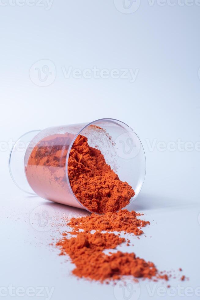 Colourful holi powder in plastic containers isolated on white background photo