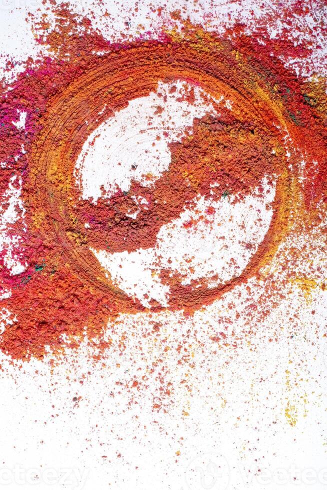 Multicolored holi powder in the form of a circle on a white background. photo