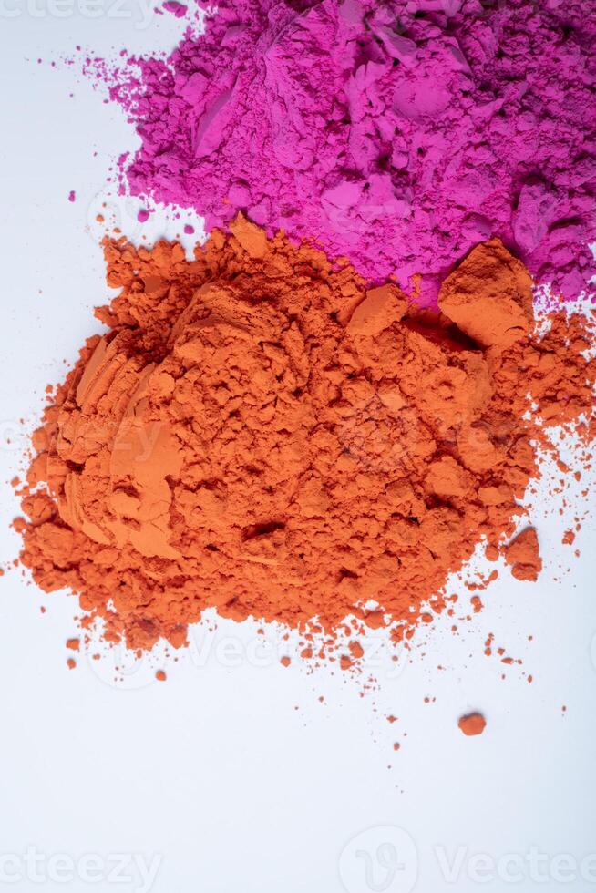 Pile of colorful holi powder on white background. photo