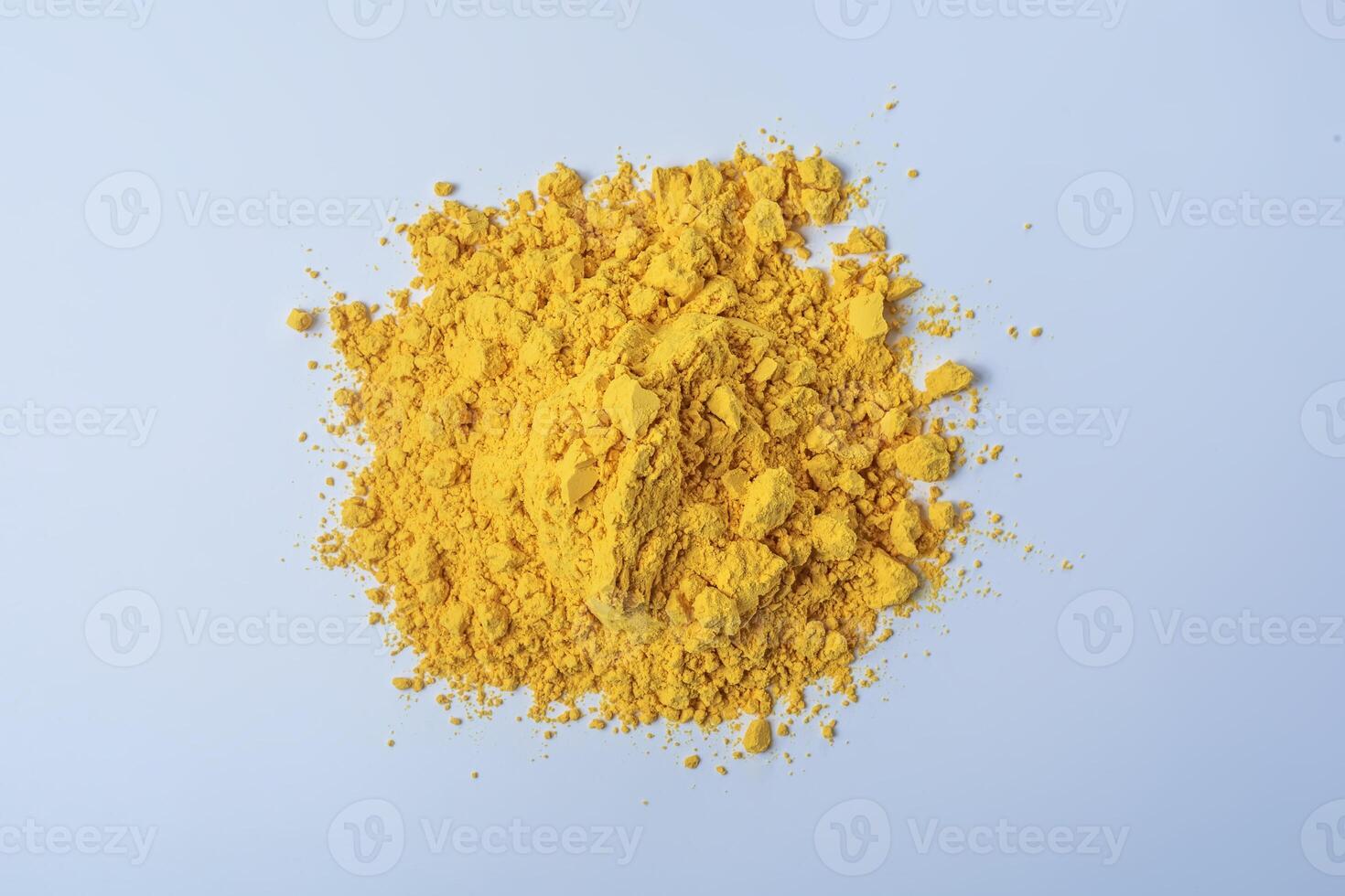 Pile of yellow color holi powder isolated on white background. photo