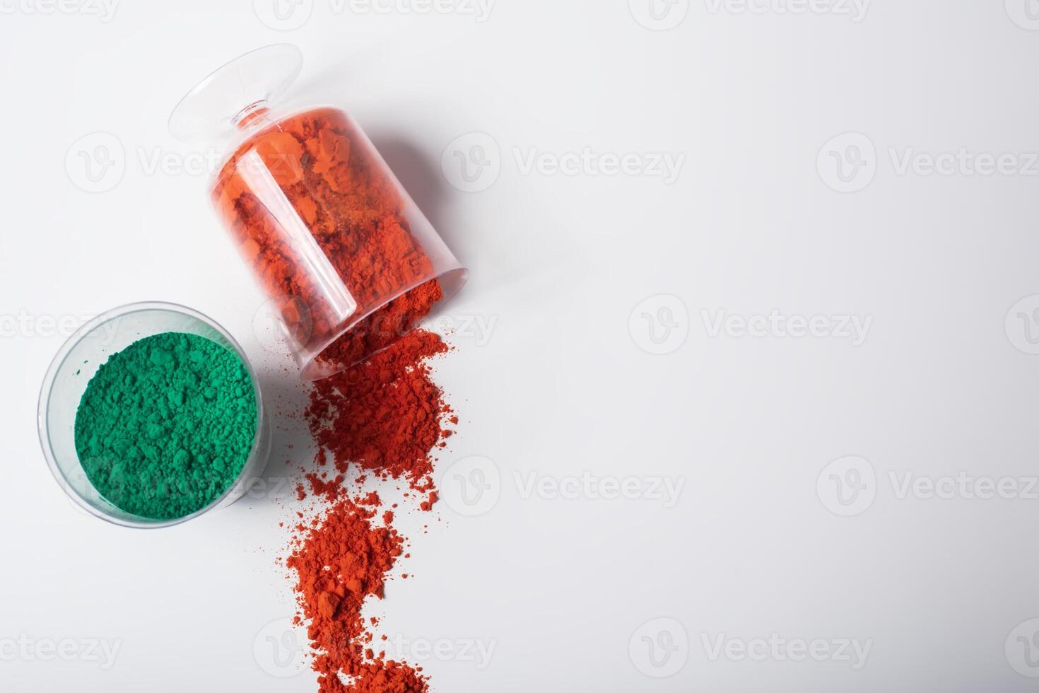 Colorful holi powder in a glass container on a white background photo