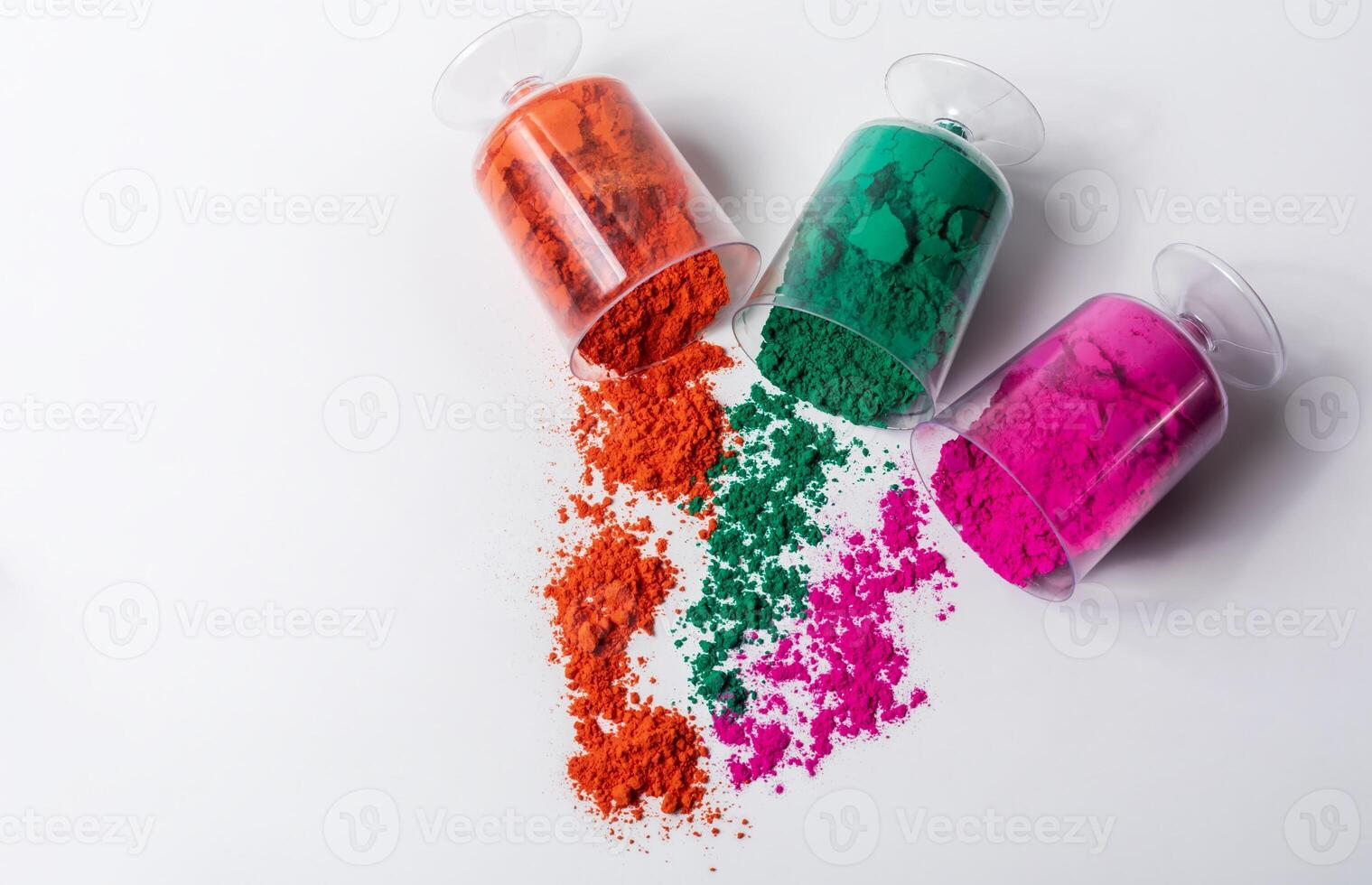 Tricolor Holi powder in plastic containers on white background. photo
