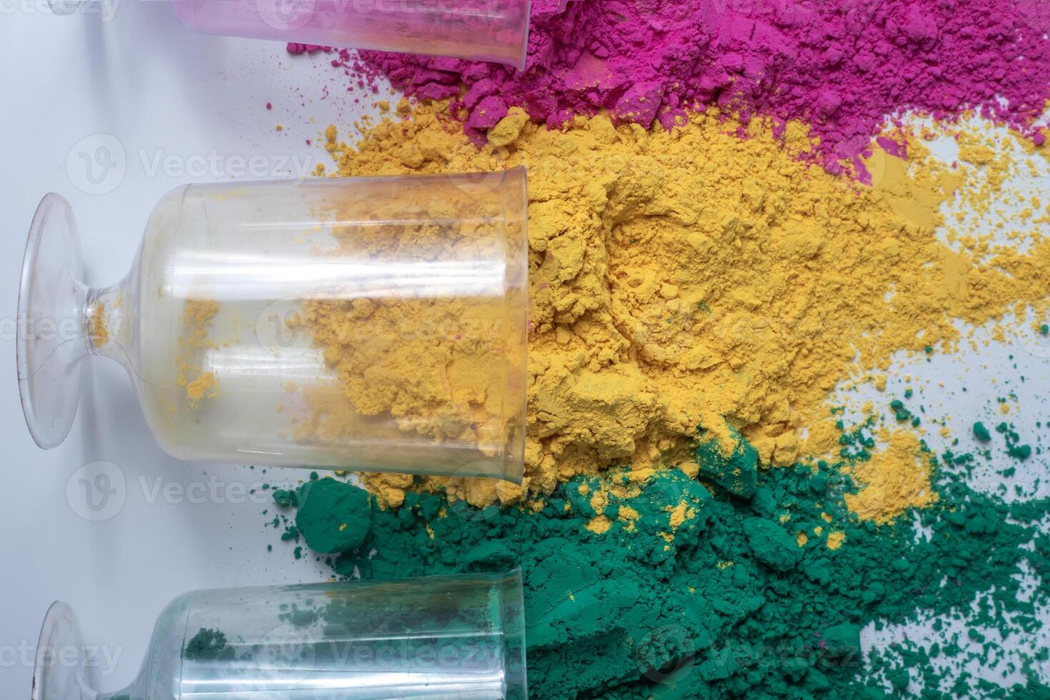 Multicolored holi powder in glass jars on white background. photo
