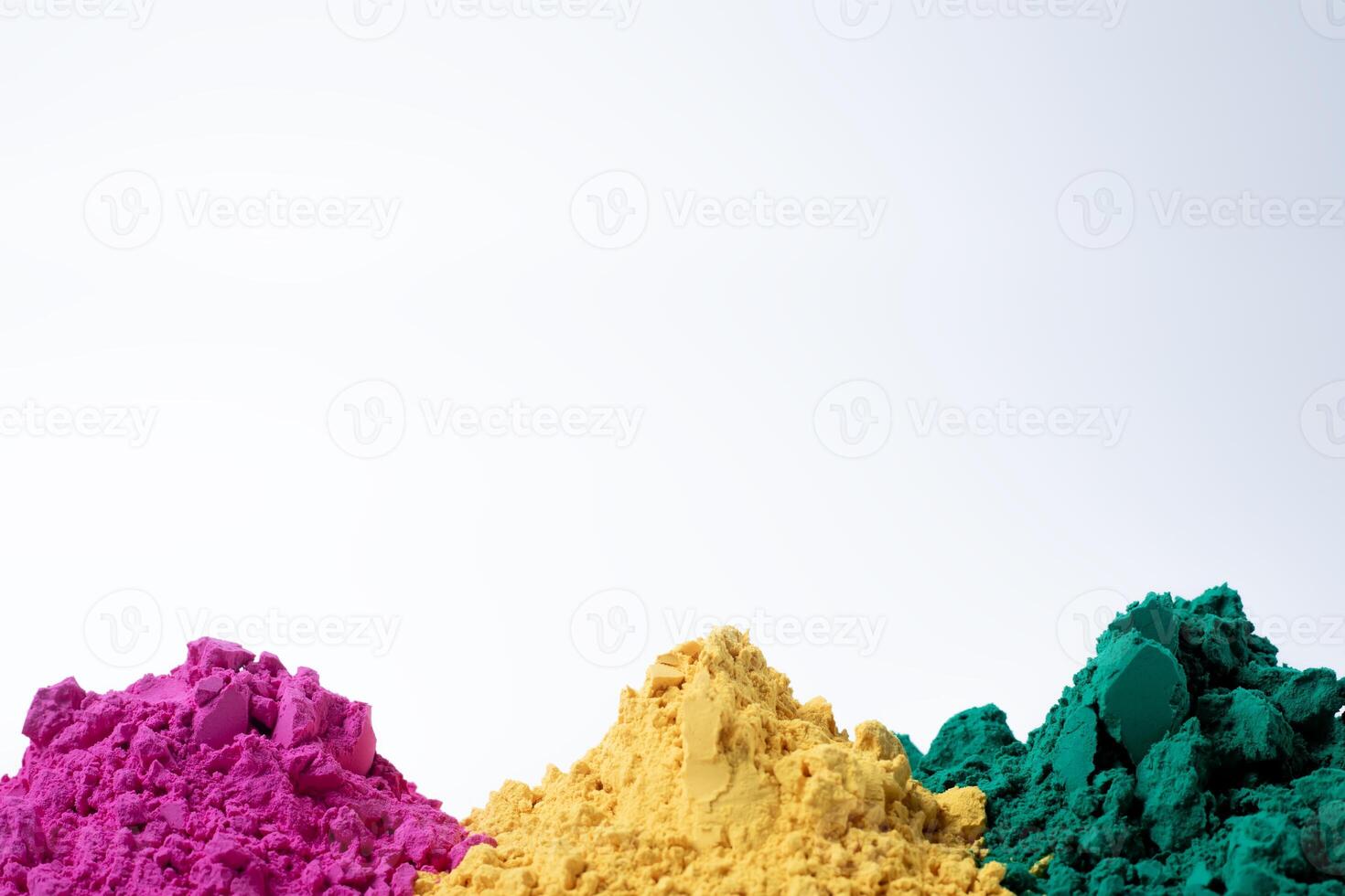 Colorful holi powder isolated on white background with copy space. photo