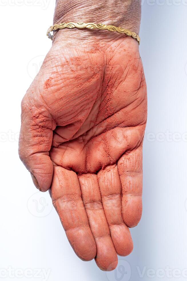 Close-up of human hand with holi powder in hand isolated on white background. photo