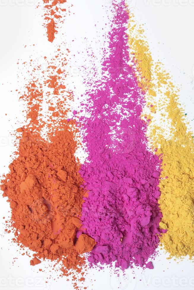 Multicolored holi powder isolated on white background. photo