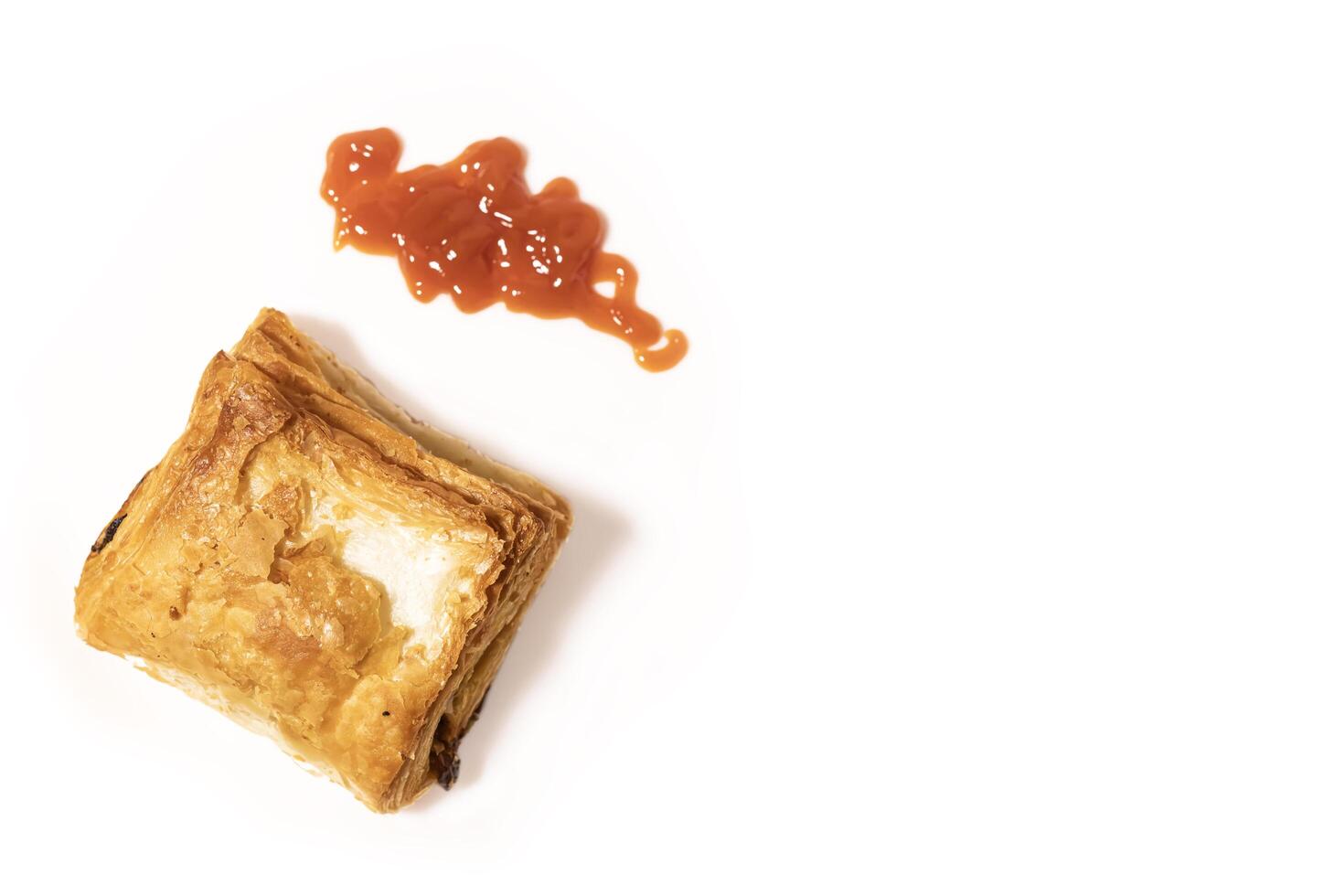 Veg puff pastry with ketchup isolated on white background photo