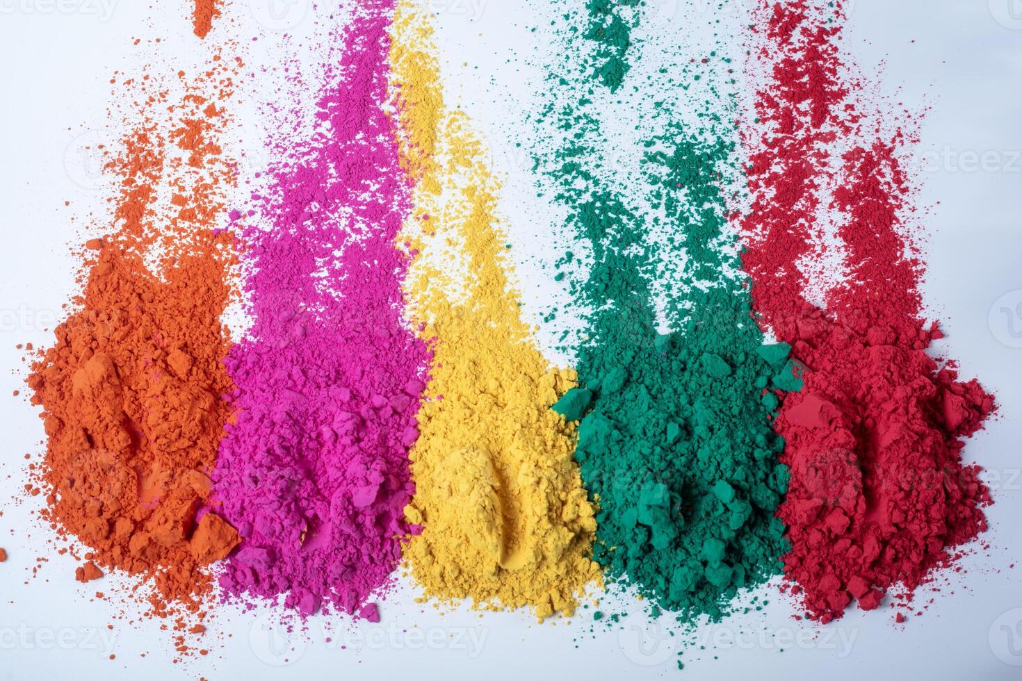 Colorful holi powder isolated on white background. Selective focus. photo