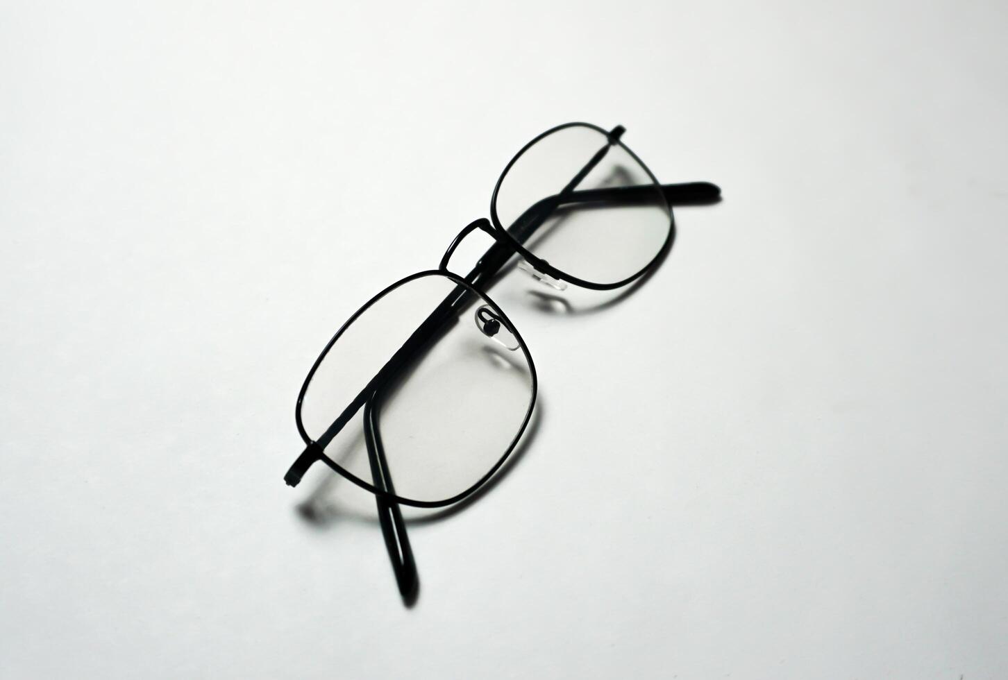 Reading glasses on white background. photo