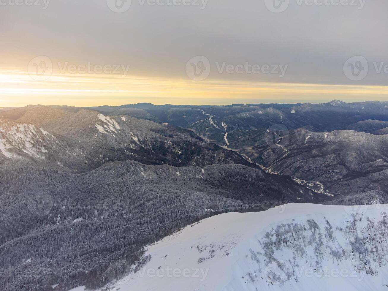 View of the winter sunset and snow-covered mountains in Sochi photo