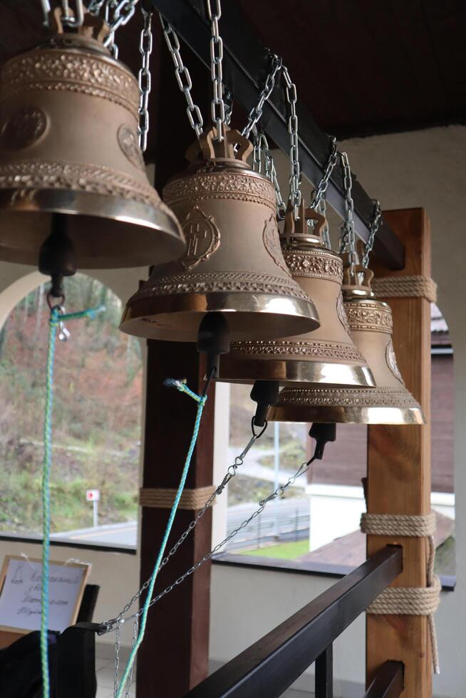 Small orthodox church bells on the church bell tower photo
