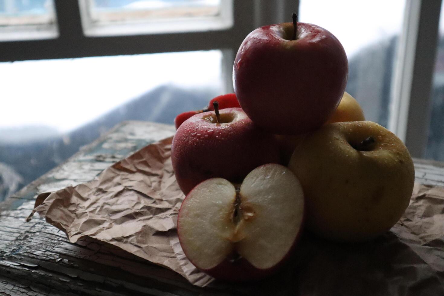 Cozy still life food photography Red apples cut half on a craft paper photo