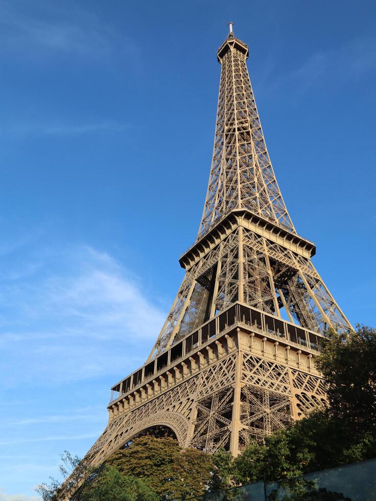 Eiffel Tower day light side view from the ground close up photo