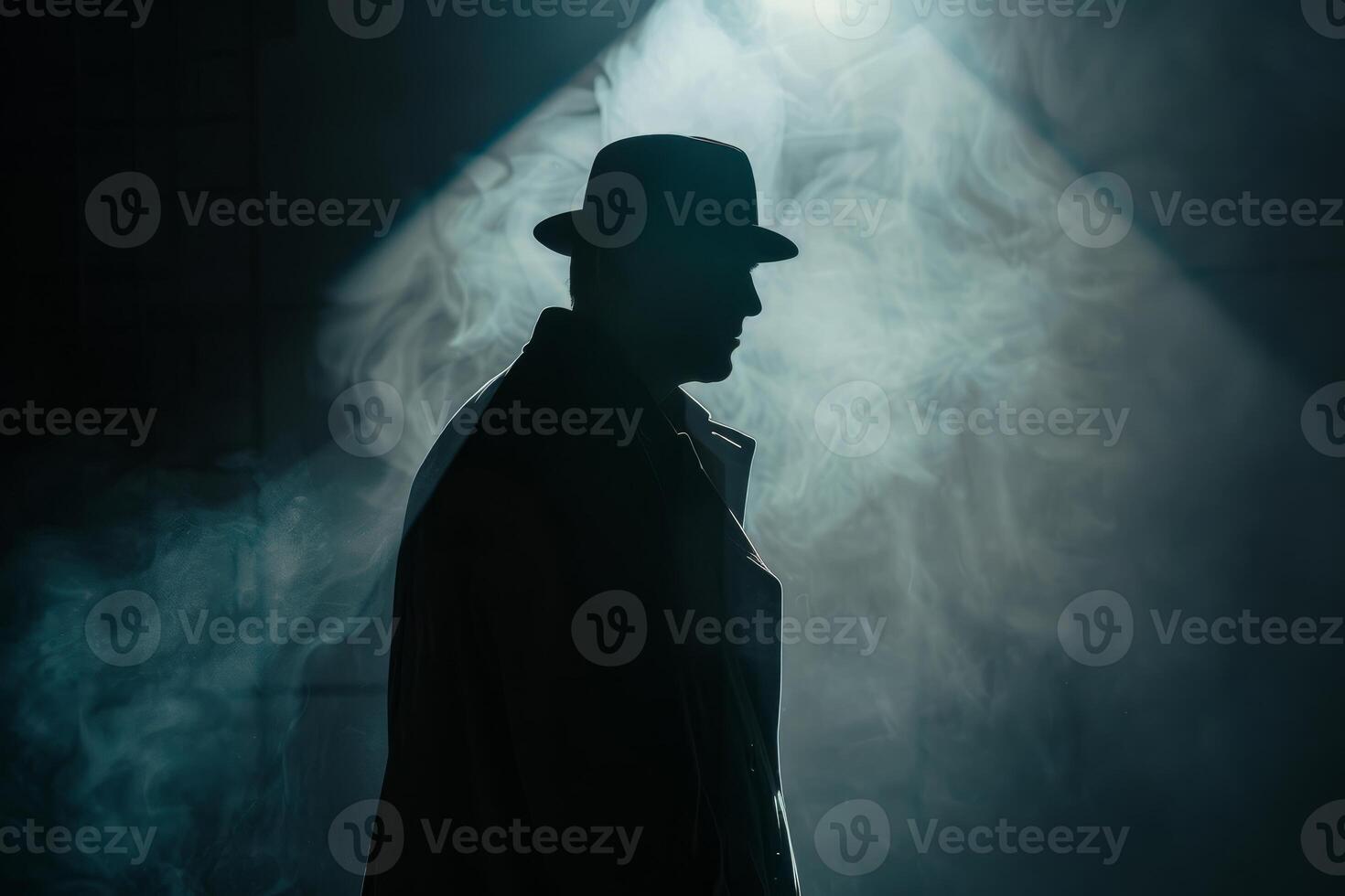 Silhouette of a man in a coat and hat photo