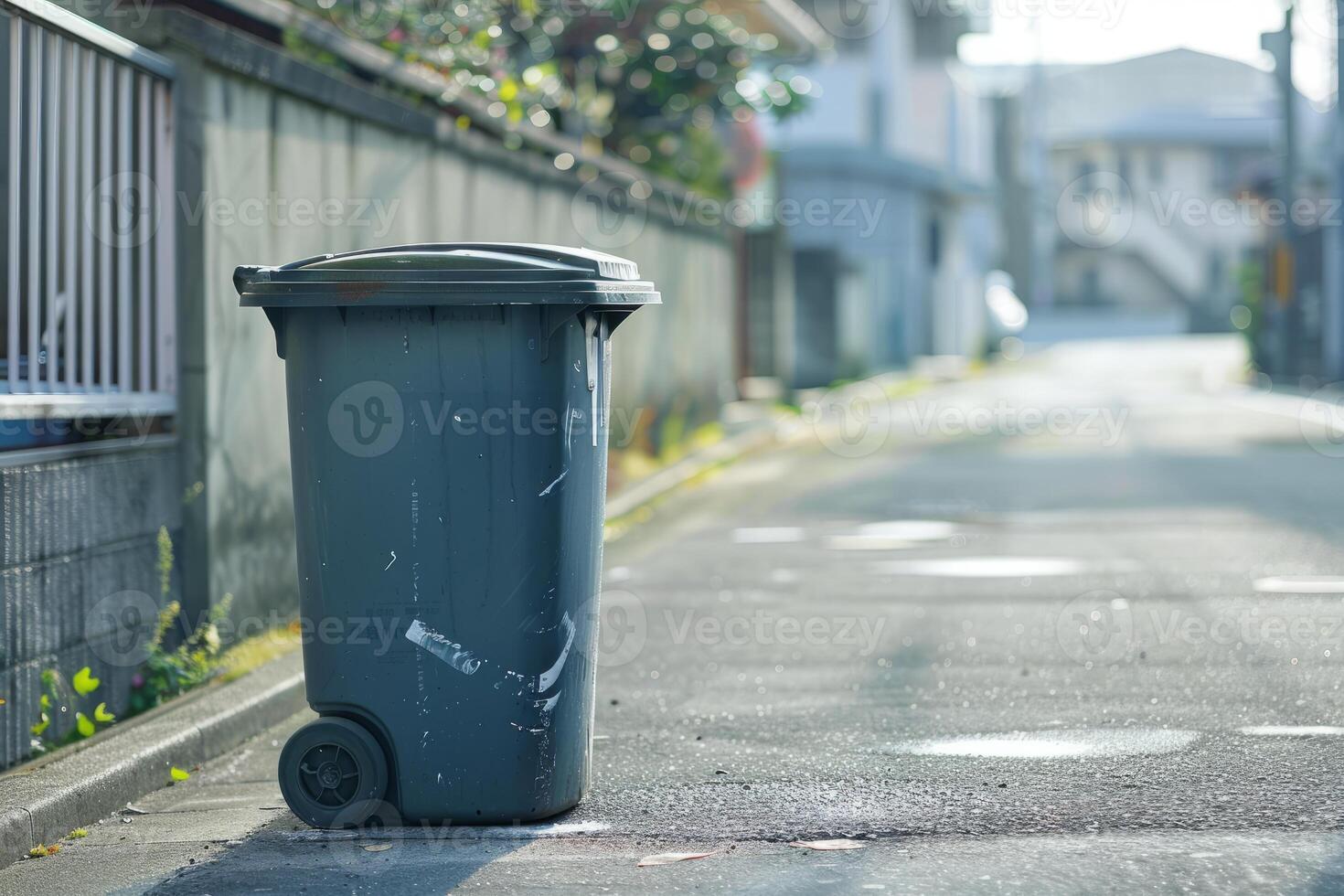 Plastic trash can on a city street photo