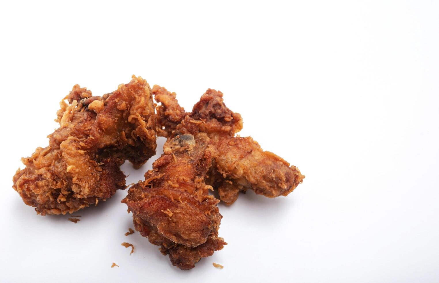 Pieces of fried chicken isolated on a white background photo