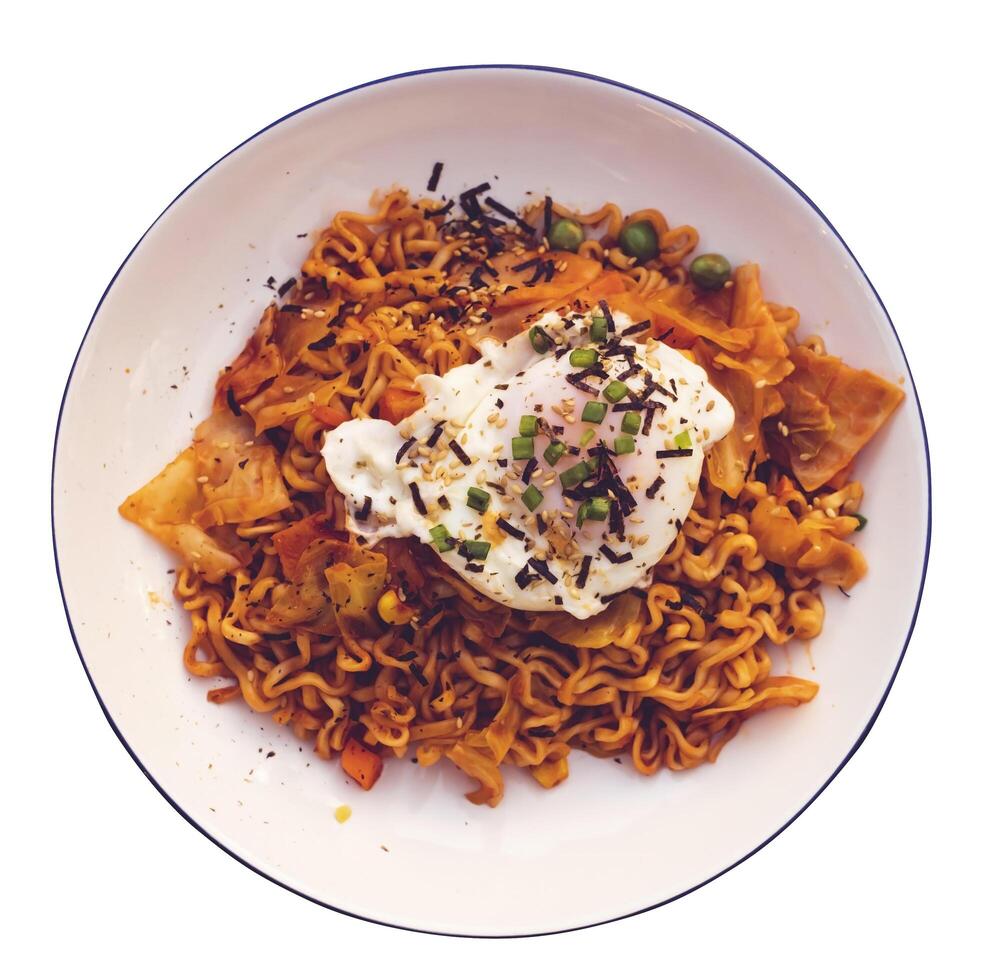 Stir fried noodles with fried egg topped with white sesame seeds and seaweed photo