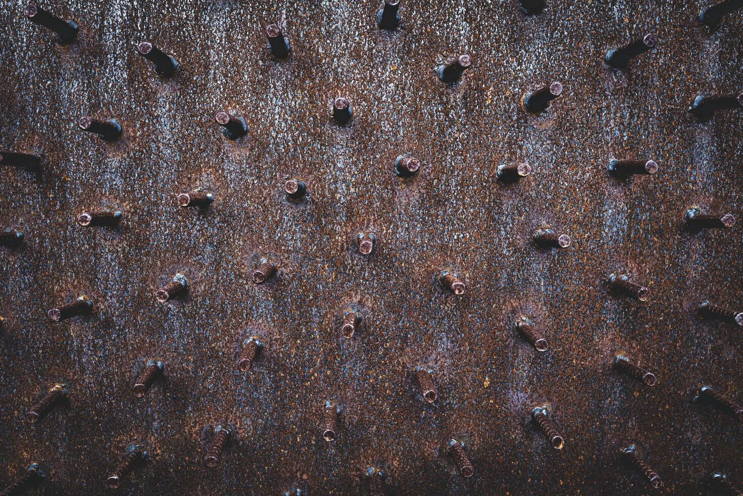 An abstraction of rusty iron bars cut short and occluded with large iron plates. photo