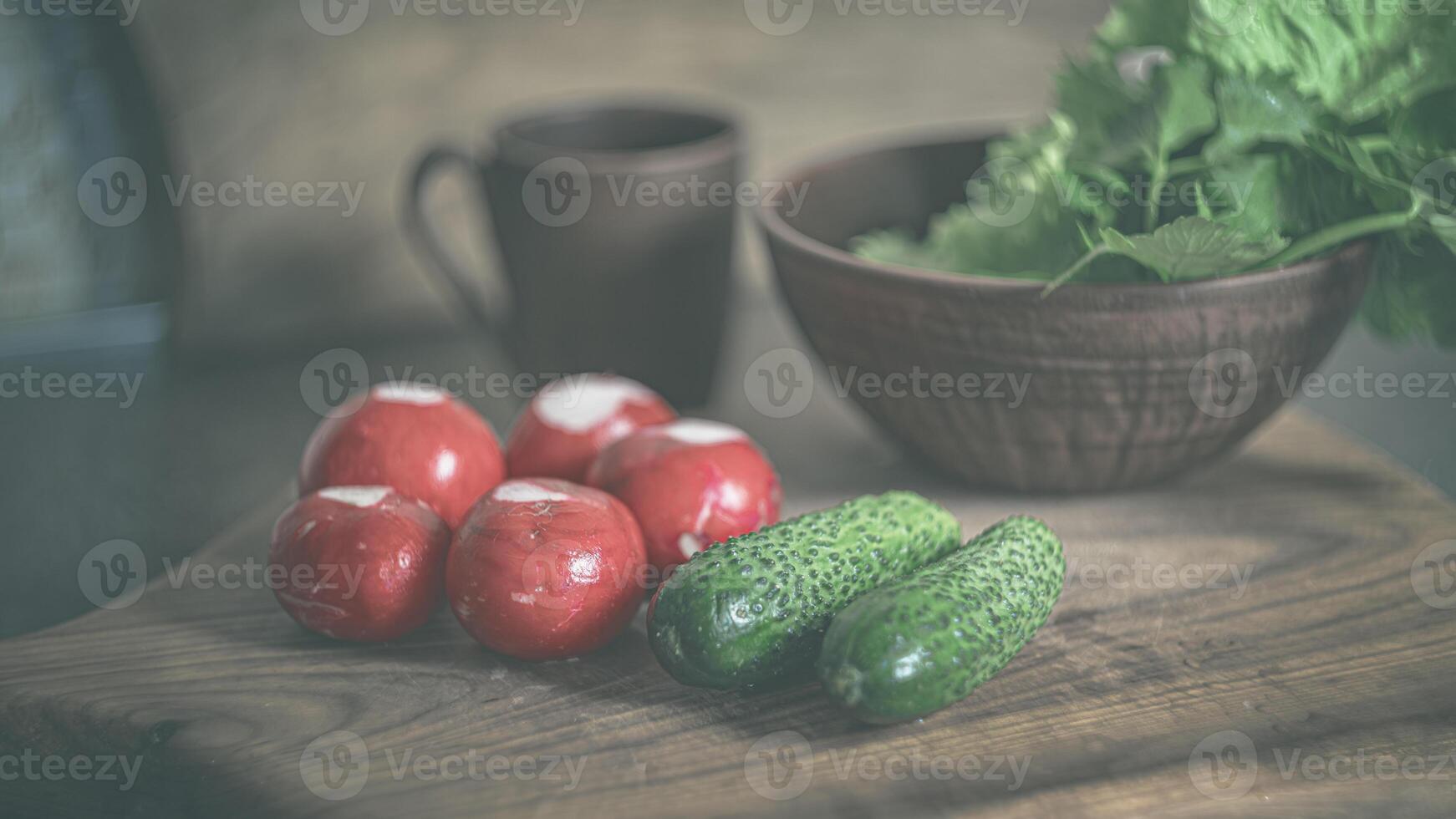 Home kitchen. Salad in a clay plate. Radishes, cucumbers, lettuce. Spring salad. Poster 16-9 photo