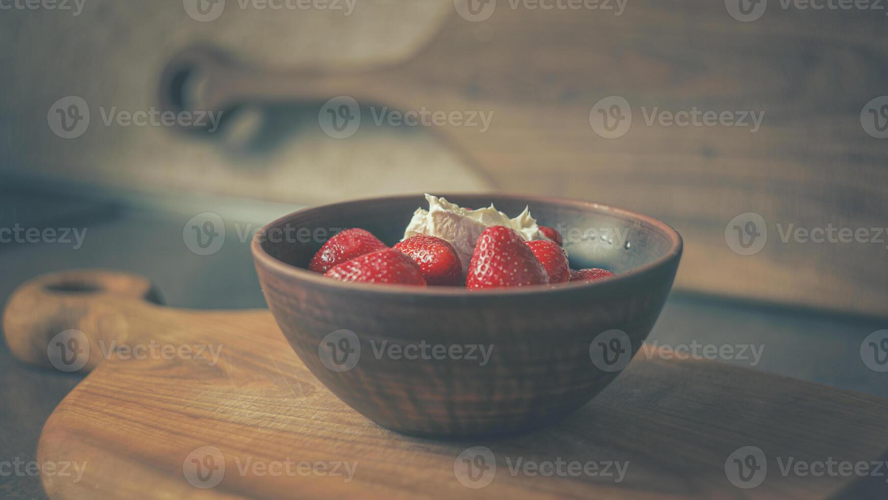 Juicy strawberries with cream in a clay plate on a wooden board. POSTER 16-9 photo