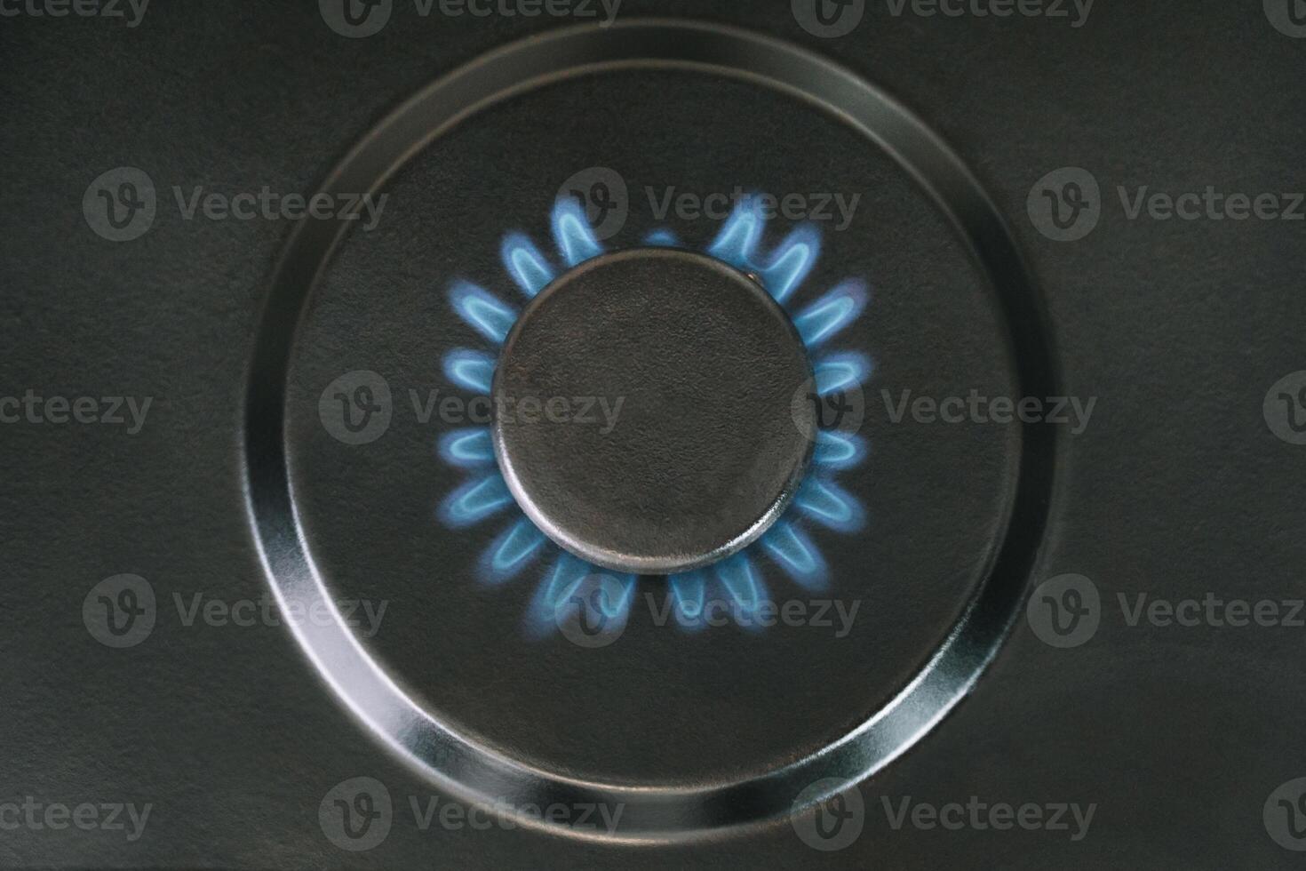 Gas is switching on, appearing blue flame. Kitchen burner turns on photo