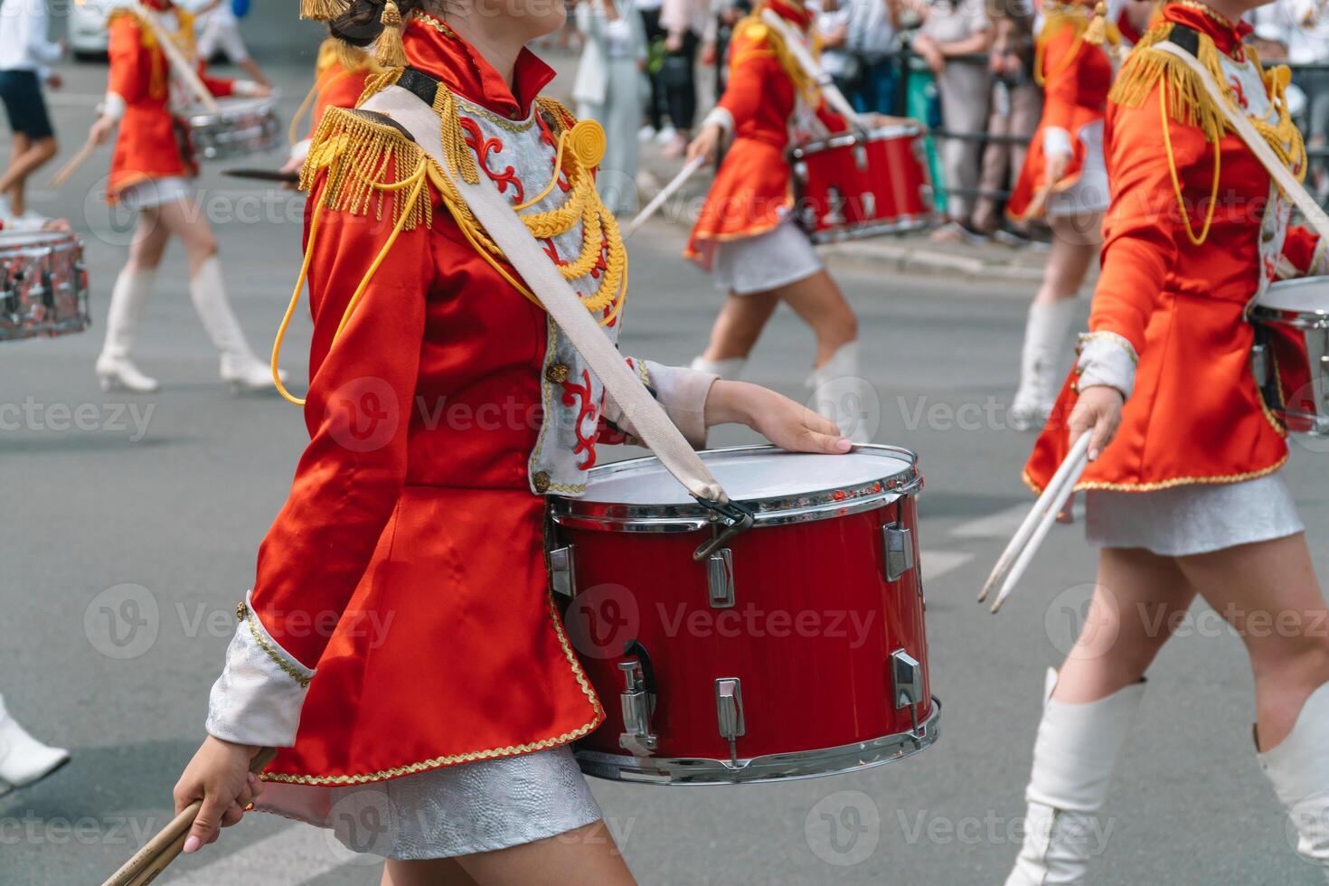 Street performance. Close-up of female drummers hands in red vintage uniform at the parade photo