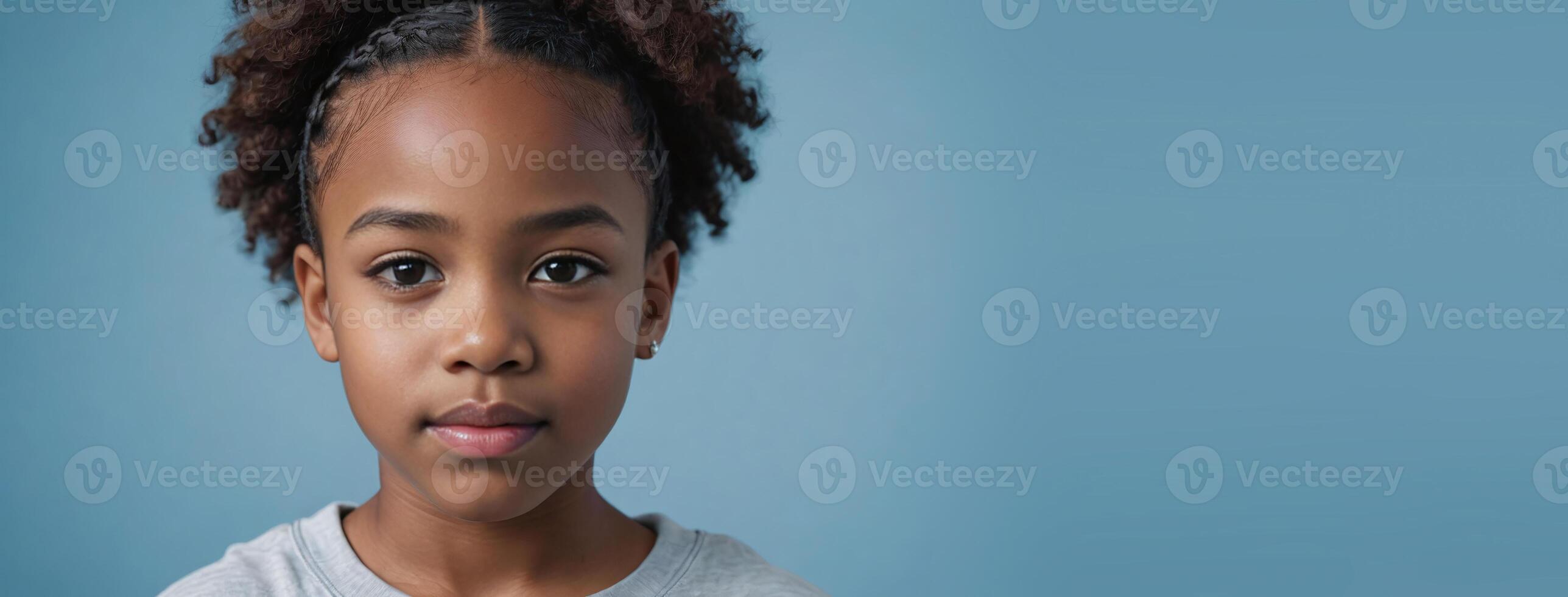 An African American Juvenile Girl Isolated On A Light Blue Background With Copy Space. photo