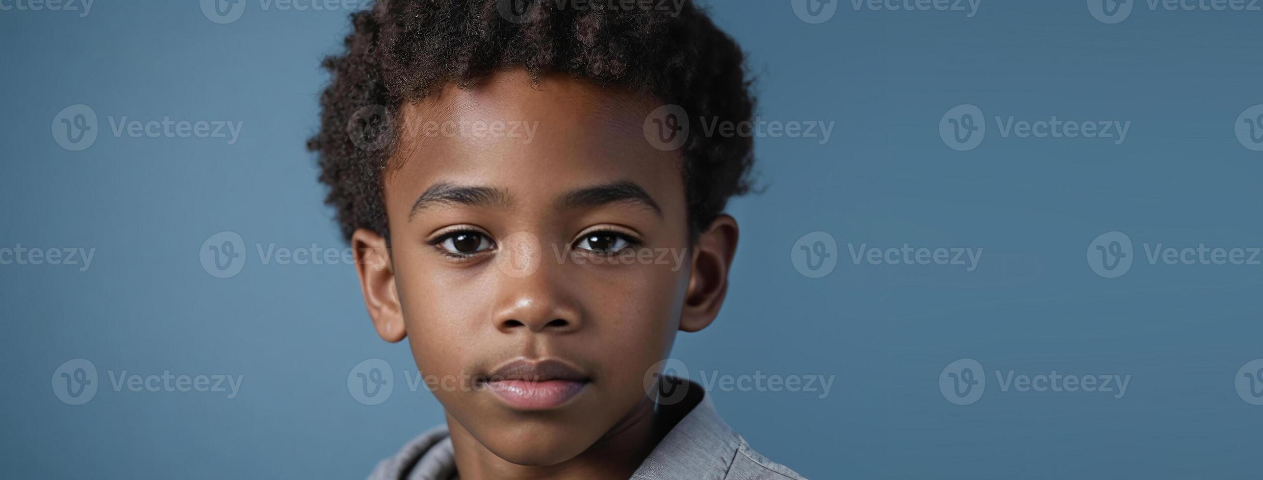 An African American Kin Boy Isolated On A Blue Background With Copy Space. photo