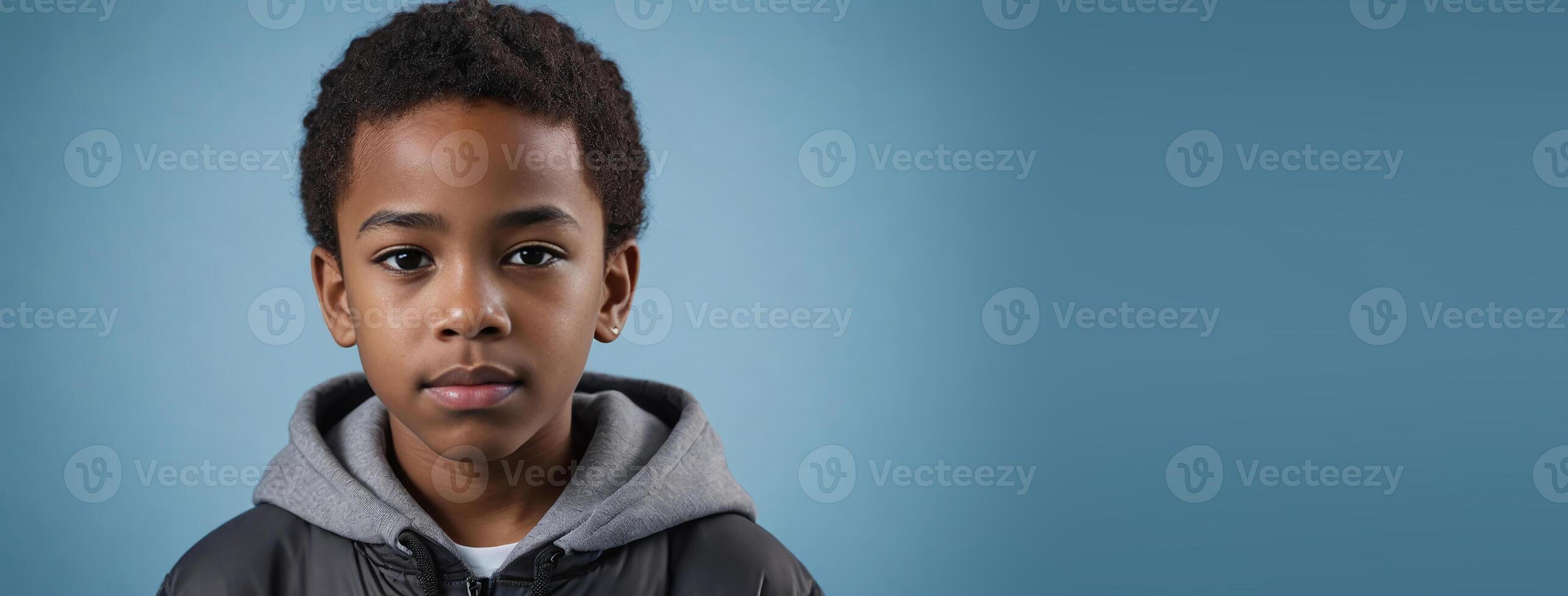 An African American Youngster Boy Isolated On A Ice Blue Background With Copy Space. photo