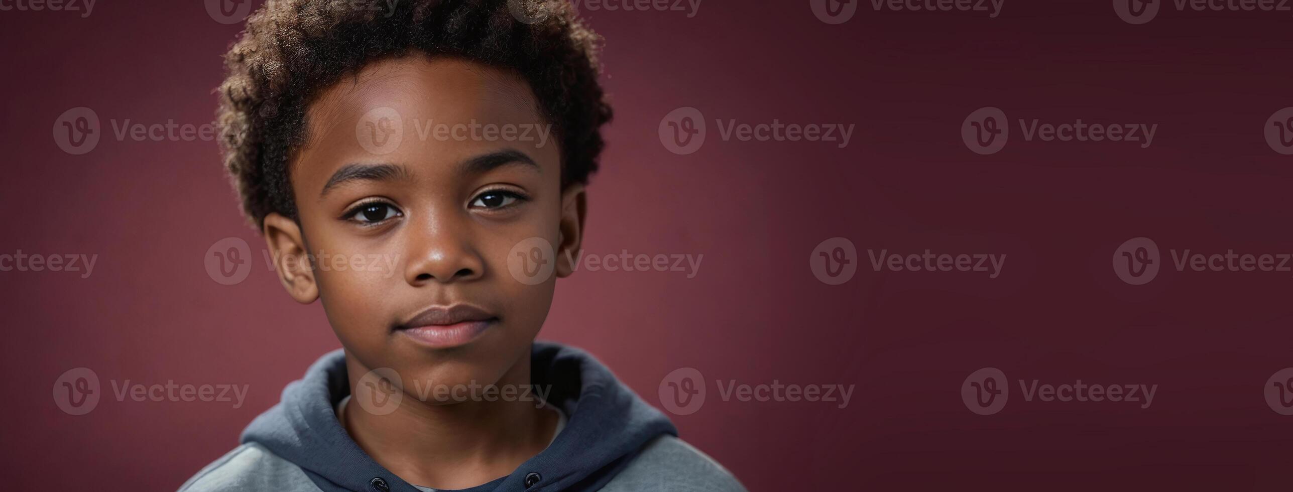 An African American Juvenile Boy Isolated On A Ruby Background With Copy Space. photo