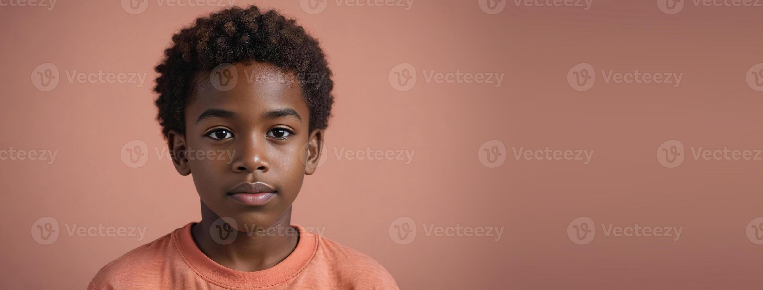 An African American Kin Boy Isolated On A Coral Background With Copy Space. photo