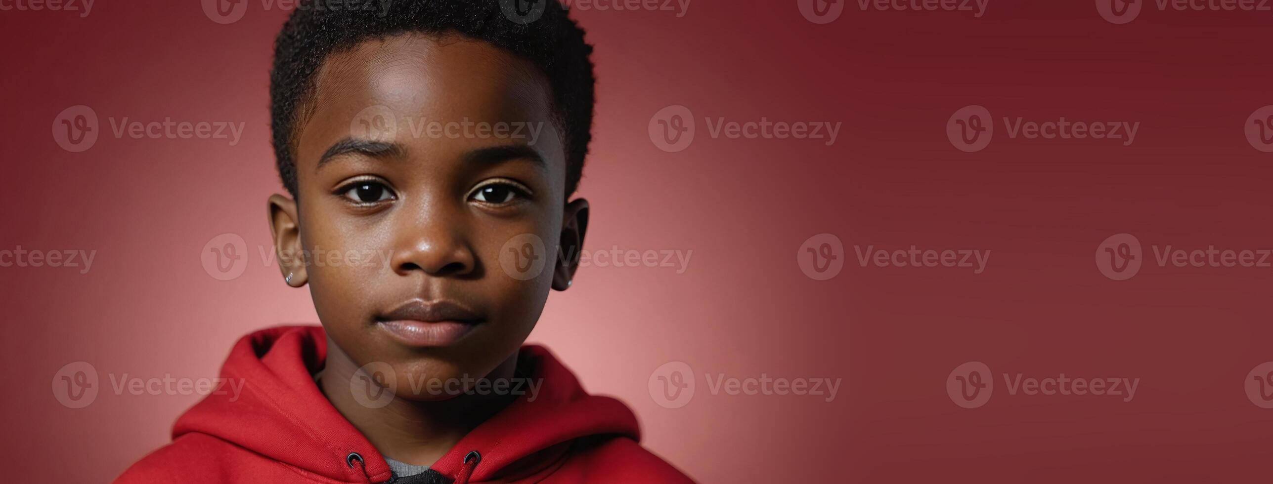 An African American Youngster Boy Isolated On A Red Background With Copy Space. photo