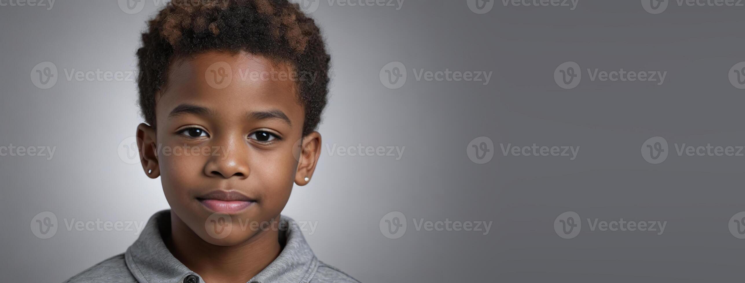 An African American Juvenile Boy Isolated On A Silver Background With Copy Space. photo