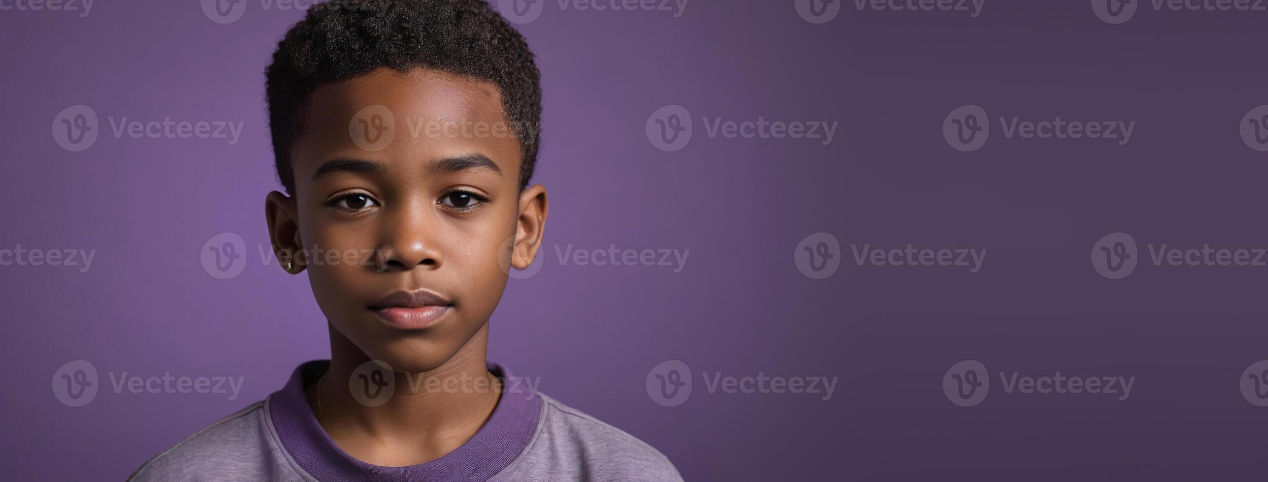 An African American Youthful Boy Isolated On A Purple Background With Copy Space. photo