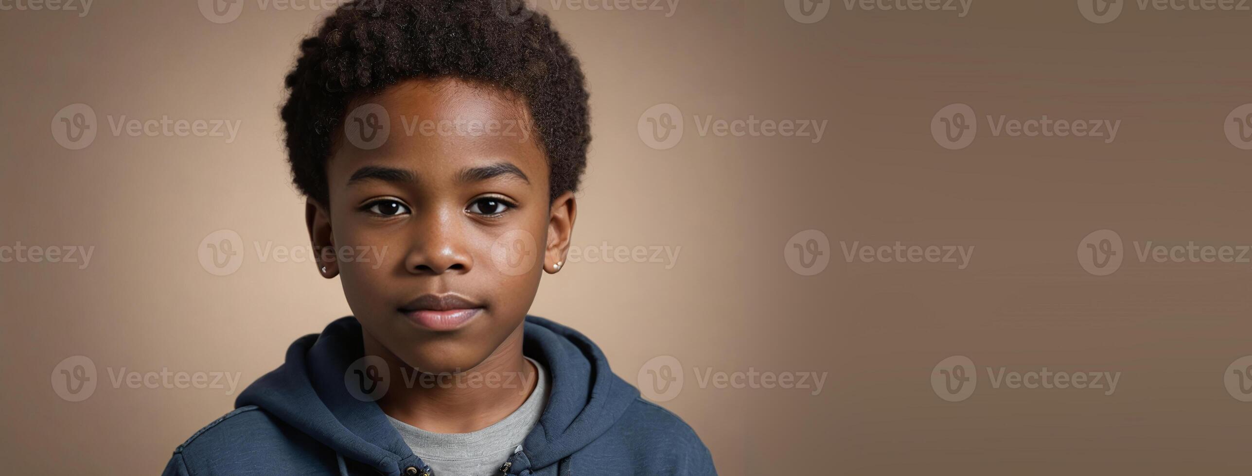 An African American Juvenile Boy Isolated On A Hazel Background With Copy Space. photo