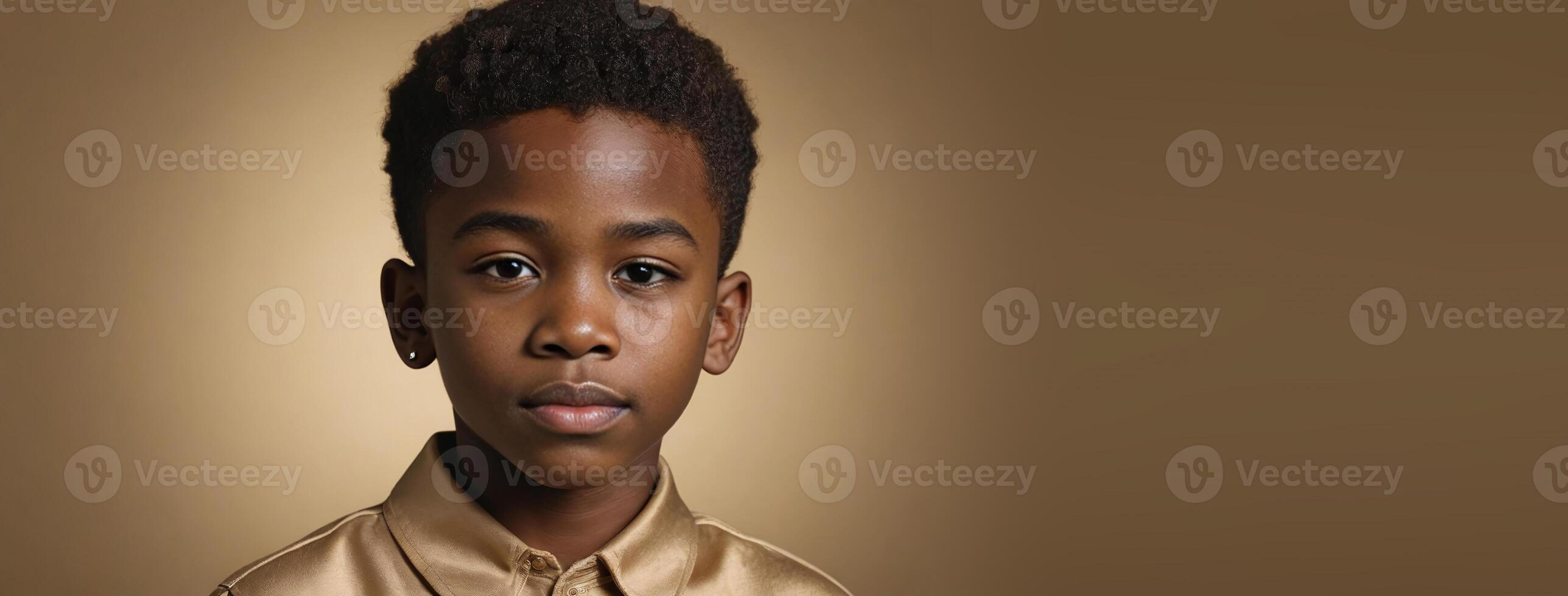 An African American Juvenile Boy Isolated On A Gold Background With Copy Space. photo