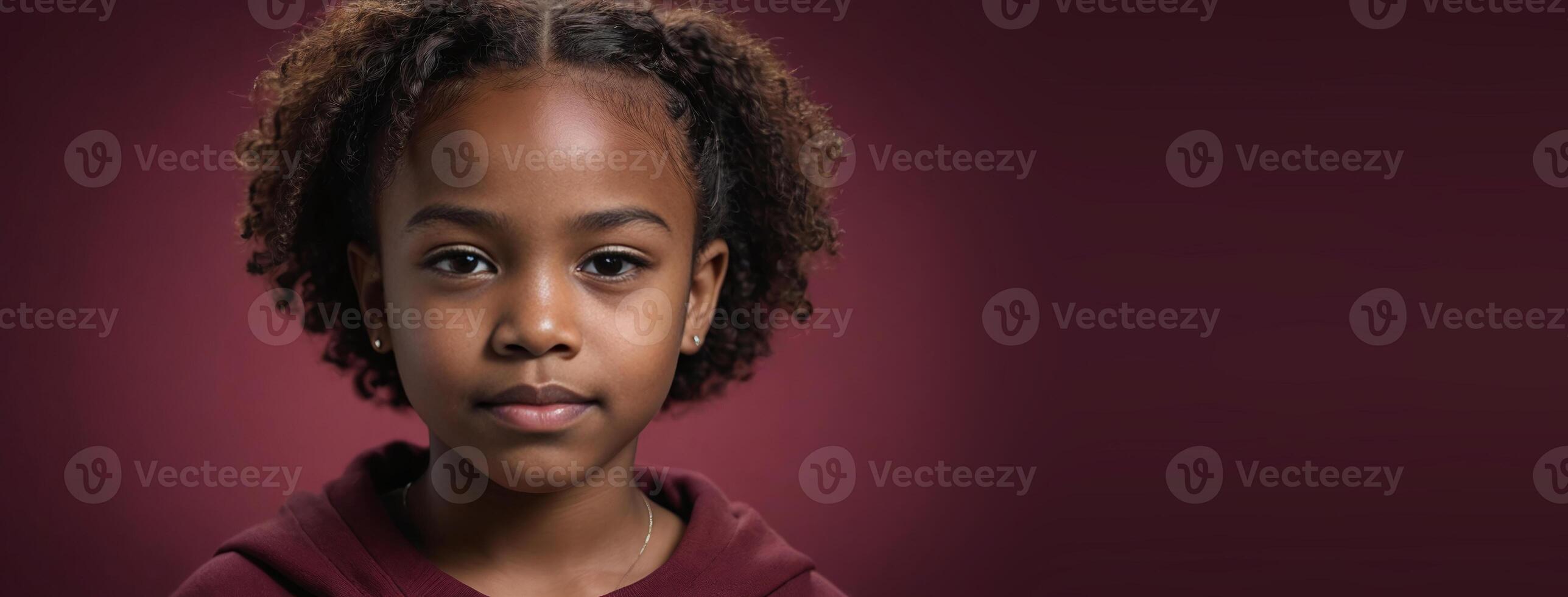 An African American Youngster Girl Isolated On A Ruby Background With Copy Space. photo