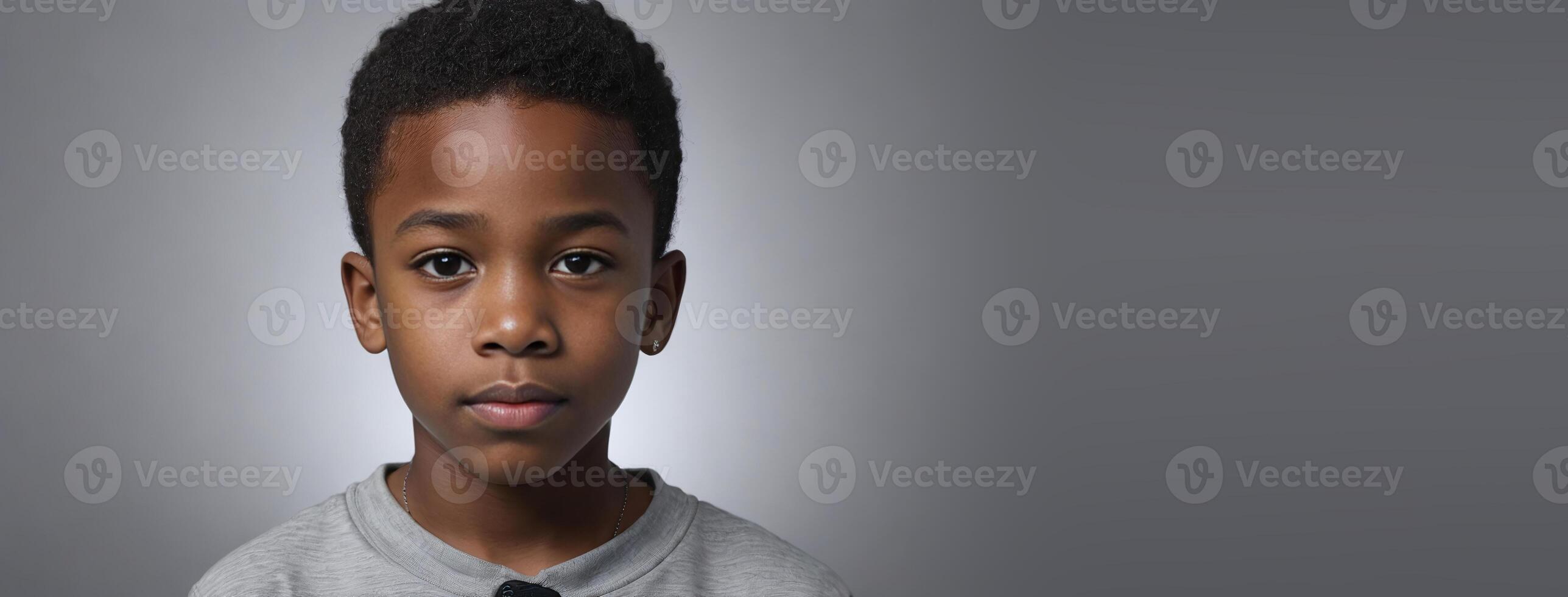 An African American Juvenile Boy Isolated On A Silver Background With Copy Space. photo
