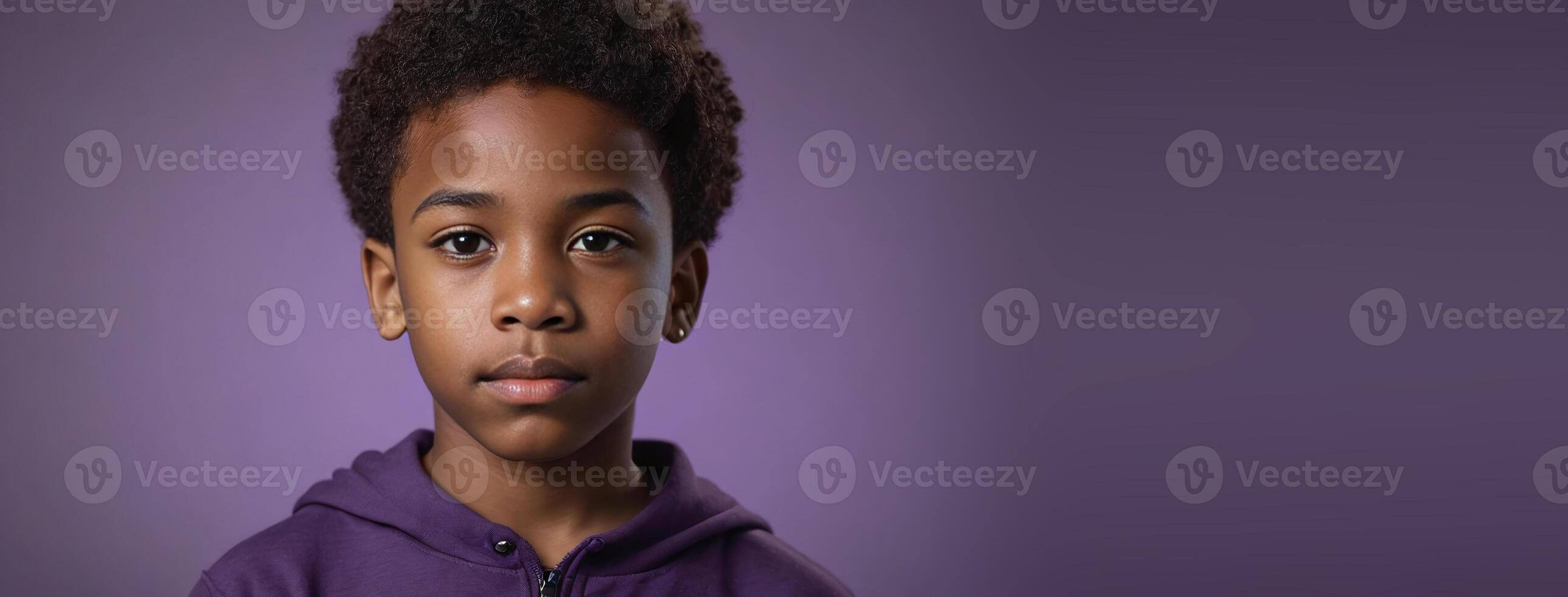 An African American Juvenile Boy Isolated On A Amethyst Background With Copy Space. photo