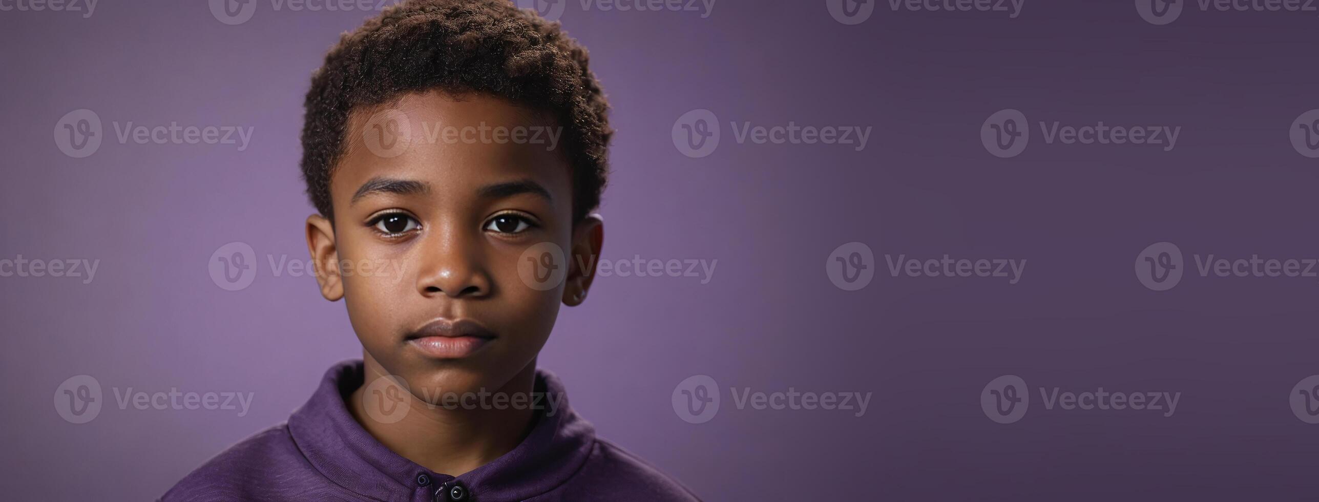 An African American Juvenile Boy Isolated On A Amethyst Background With Copy Space. photo