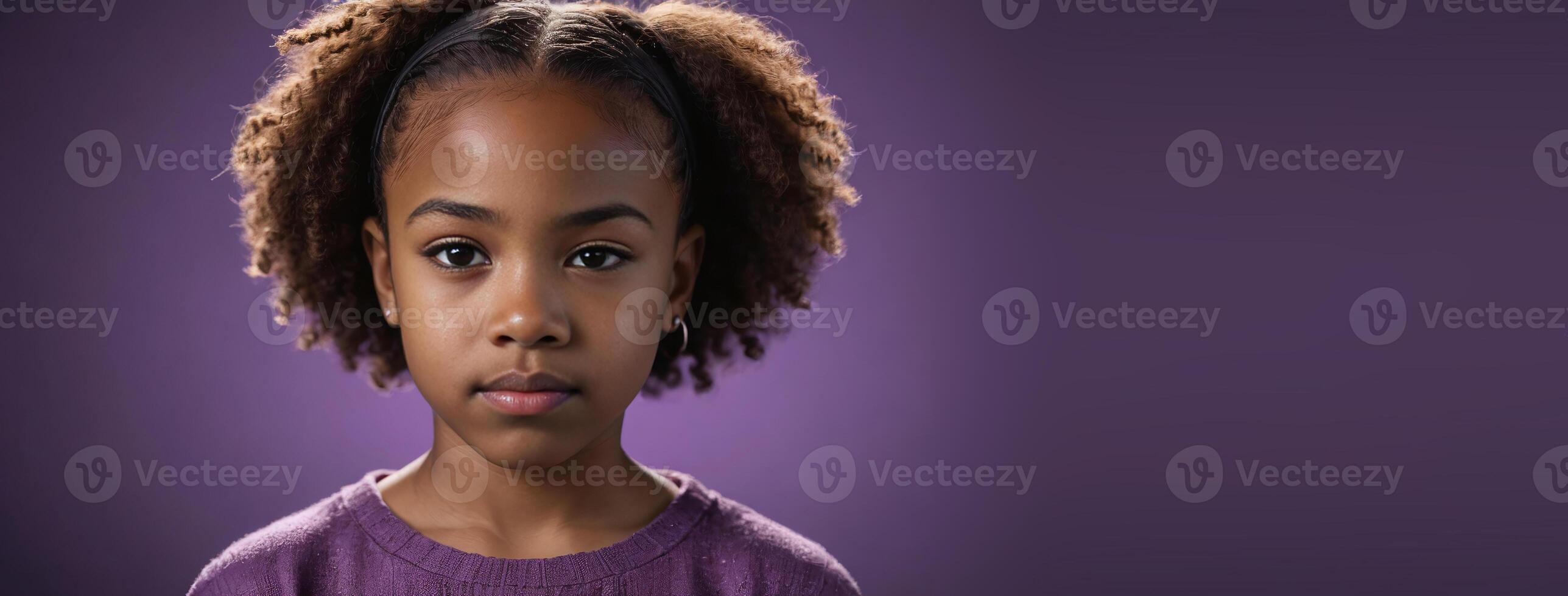 An African American Kin Girl Isolated On A Amethyst Background With Copy Space. photo