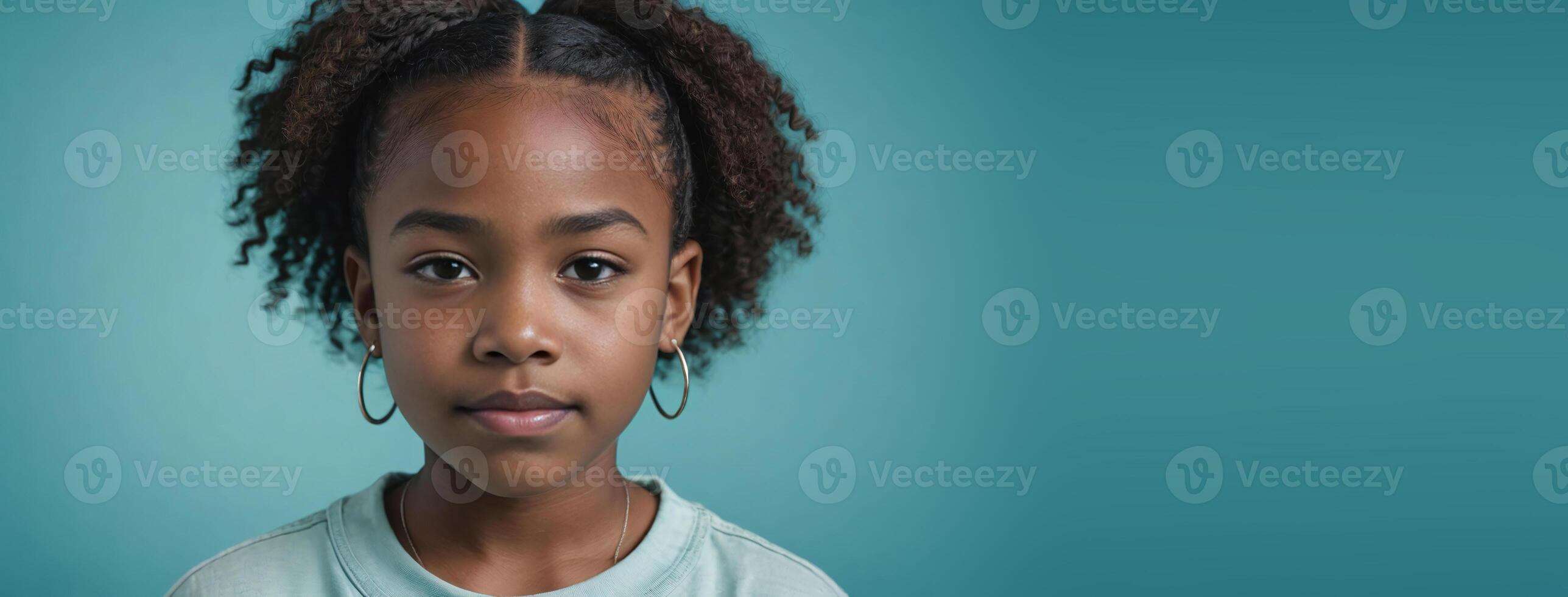 An African American Juvenile Girl Isolated On A Turquoise Background With Copy Space. photo