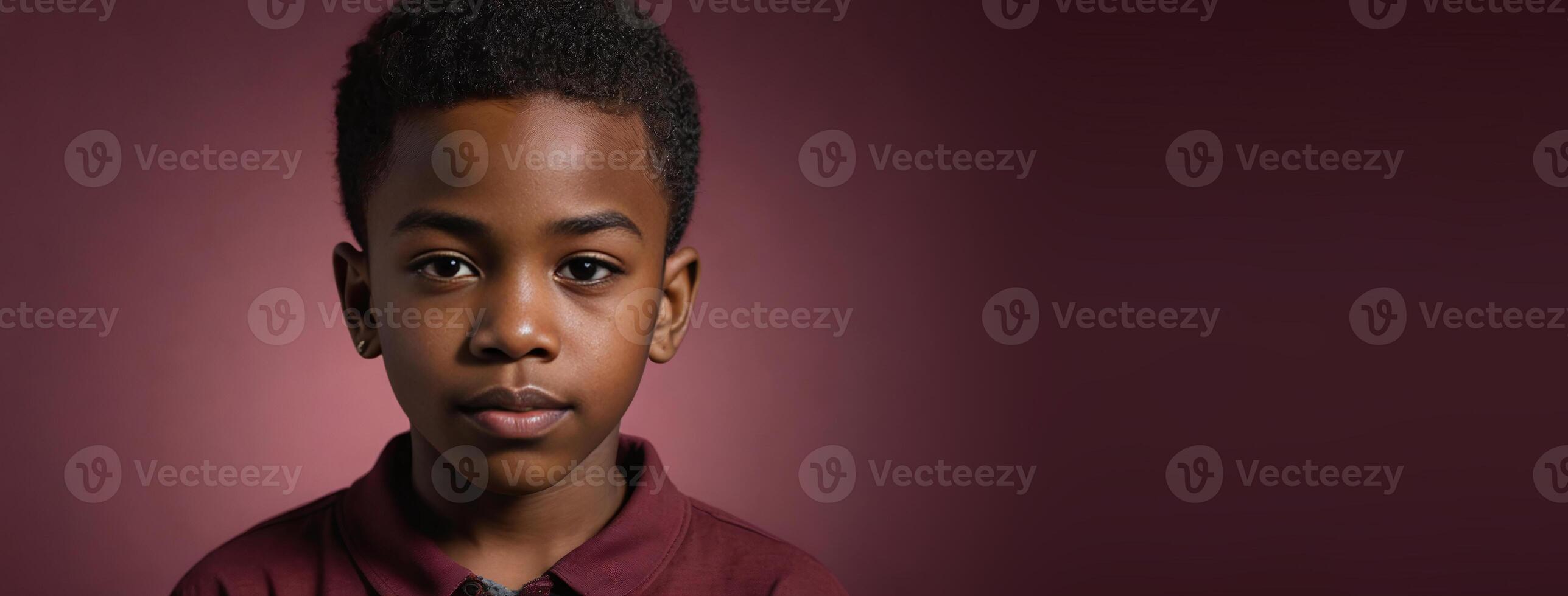 An African American Juvenile Boy Isolated On A Ruby Background With Copy Space. photo