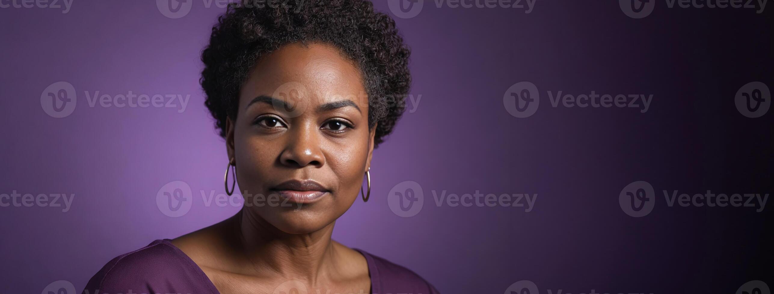 A 50S Adult African American Woman Isolated On A Purple Background With Copy Space. photo