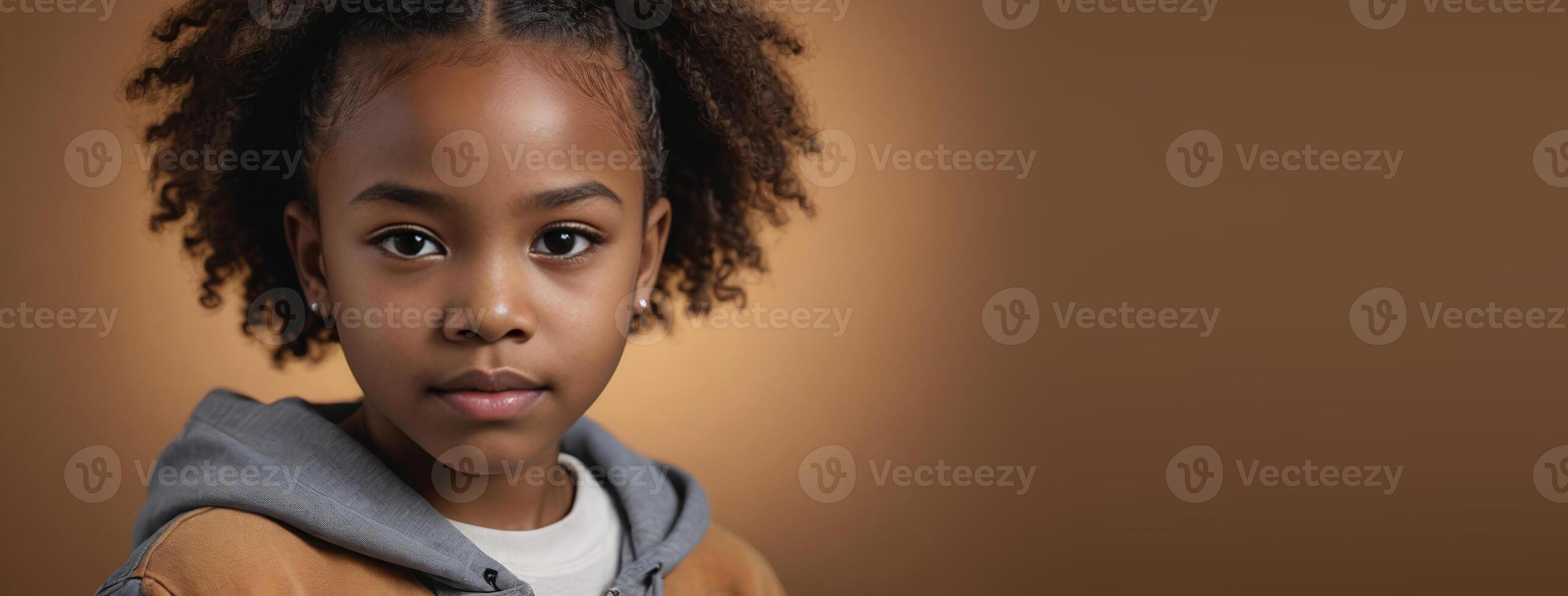 1012 Years African American Juvenile Girl Isolated On A Amber Background With Copy Space. photo