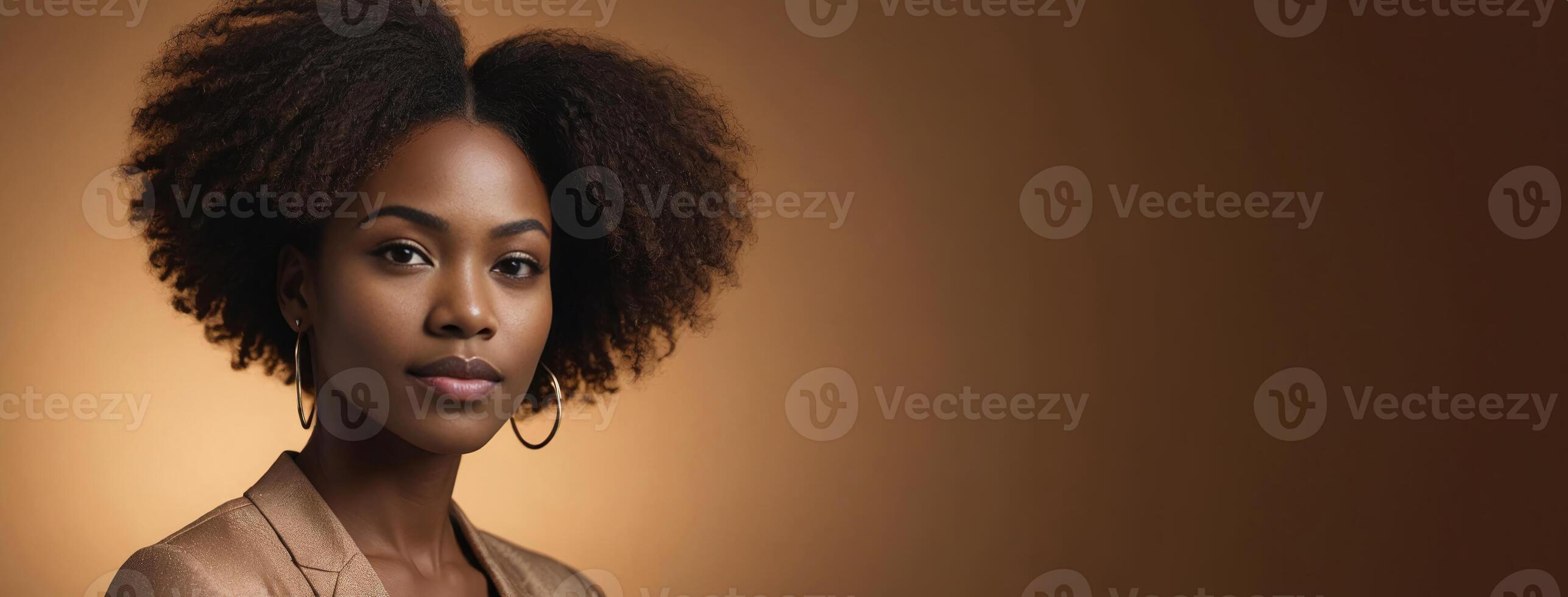 African American 2530 Years Woman Isolated On A Amber Background With Copy Space. photo