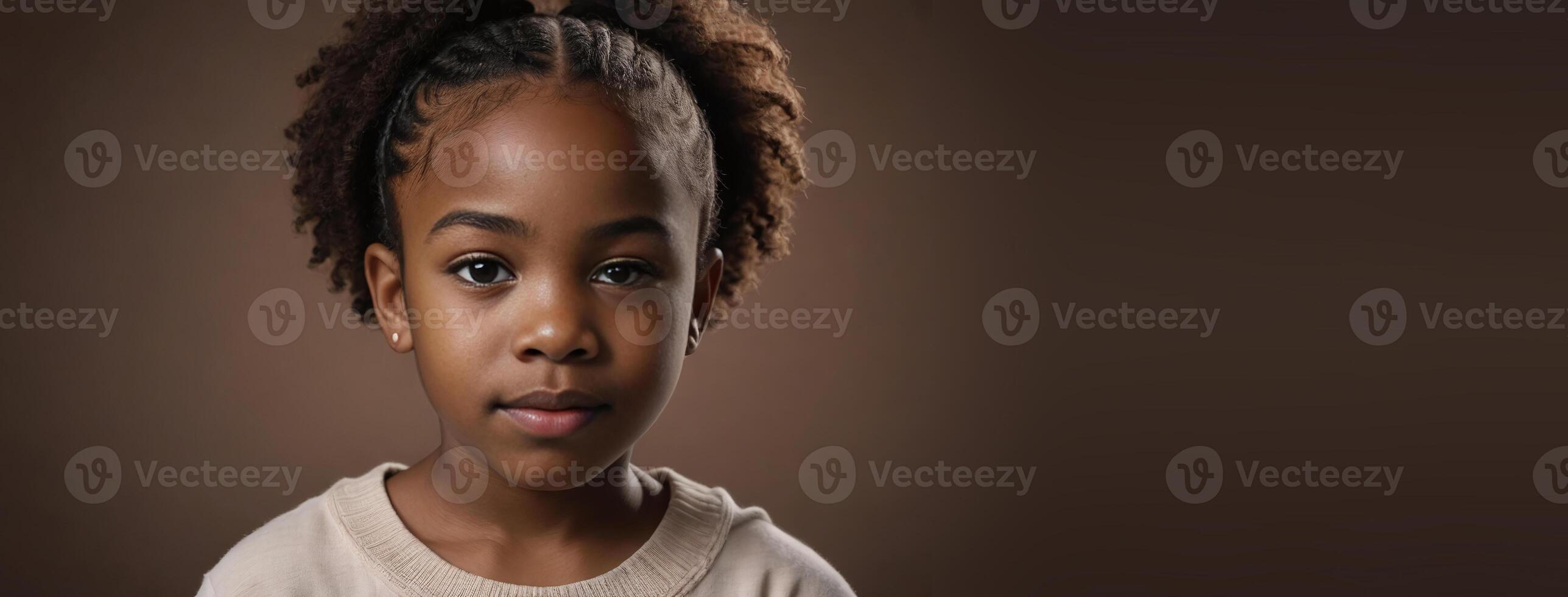 An African American Kin Girl Isolated On A Brown Background With Copy Space. photo