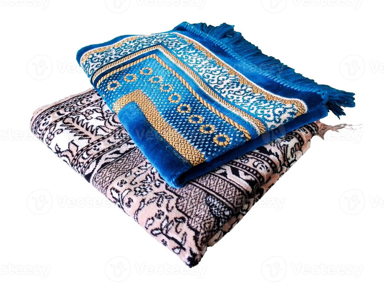 Folded Muslim prayer mat used to pay on white background photo