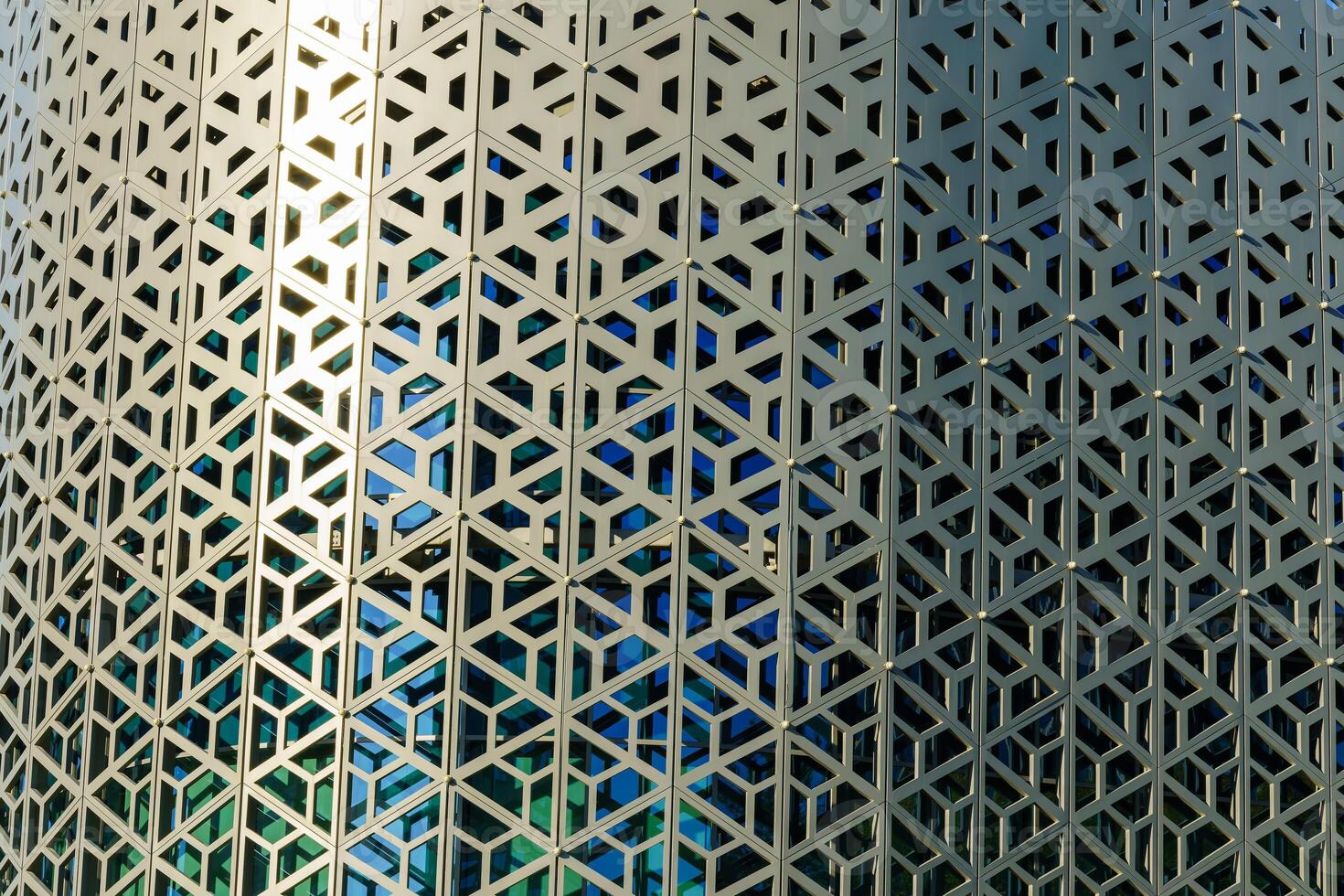 The texture of the cladding of a building made of metal aluminum panels with a carved pattern. Abstract background. photo