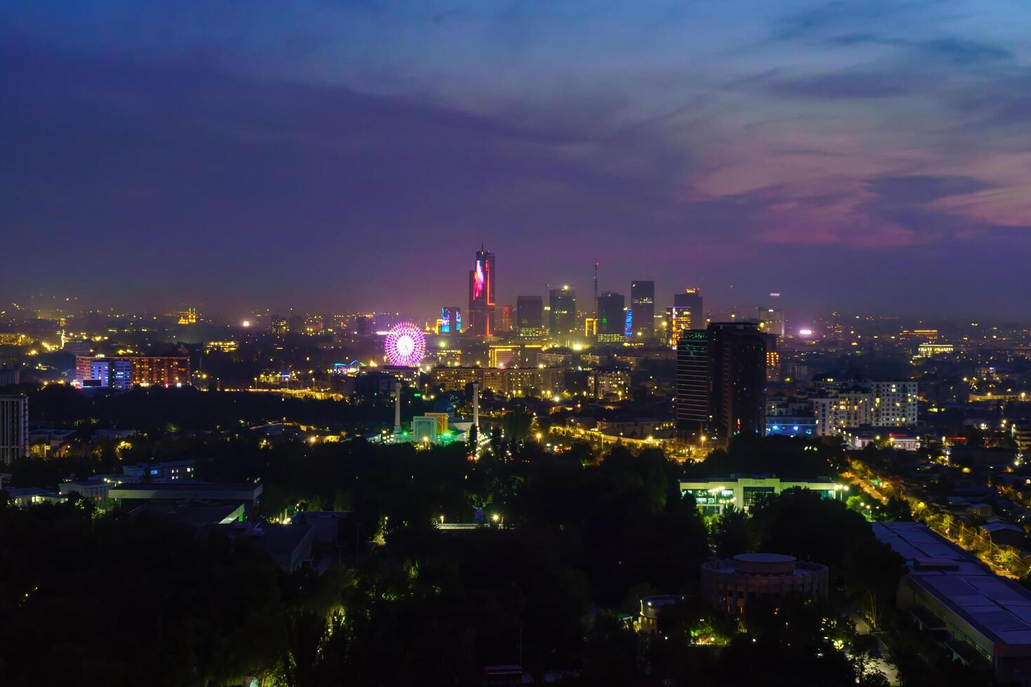 Uzbekistan, Tashkent - September 29, 2023 Top view from the observation deck on the Tashkent TV tower to the central part of the city covered with smog at nighttime . Air polution. photo